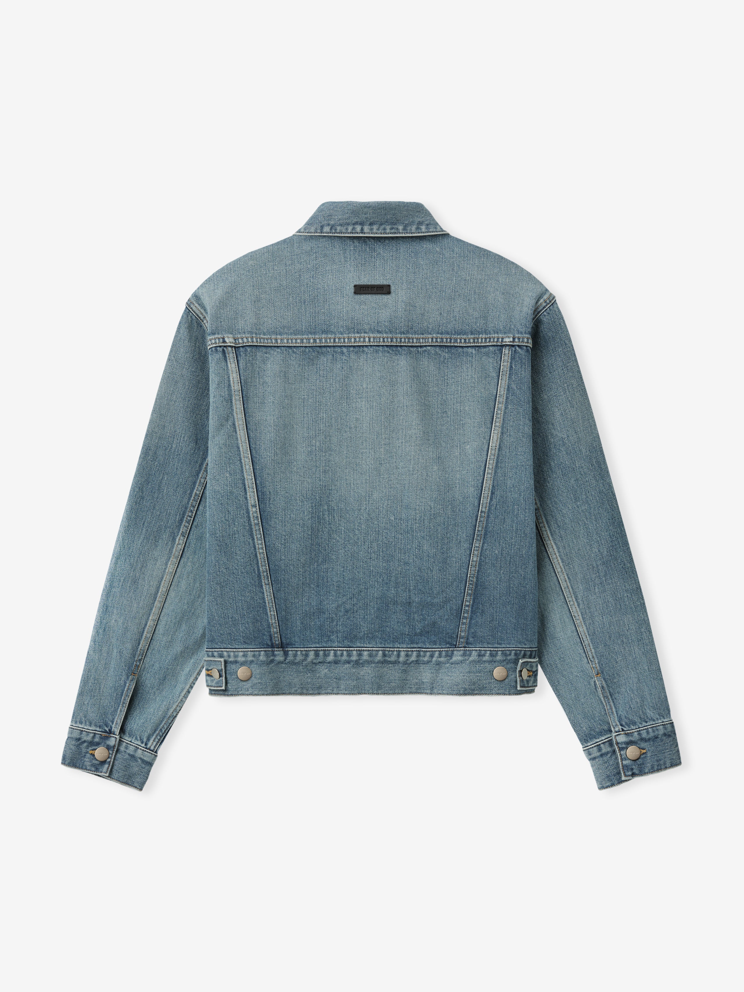 back view of men's classic trucker jacket in medium indigo denim with waistband tabs and subtle seam detailing