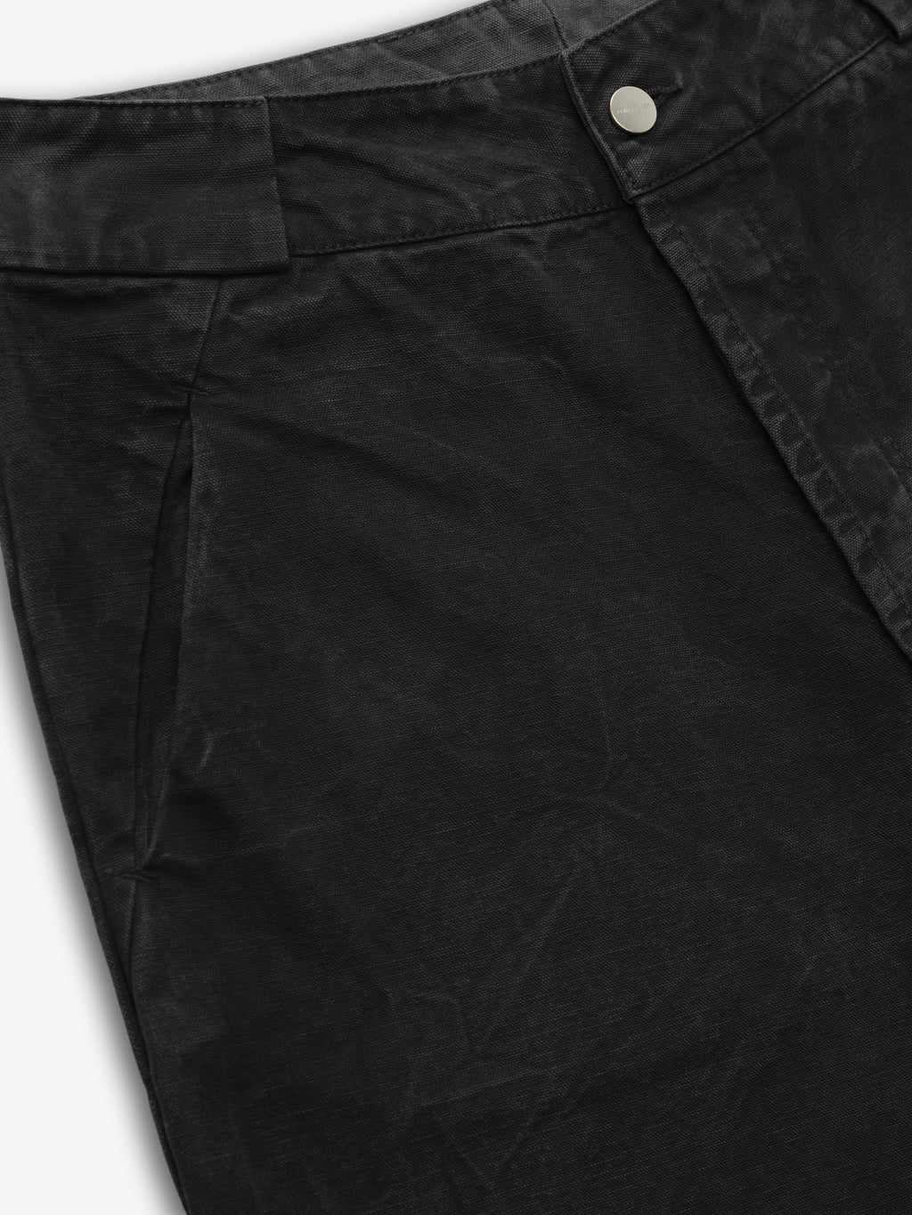 close-up of black washed canvas utility pant front with metal button closure and front seam pocket detailing