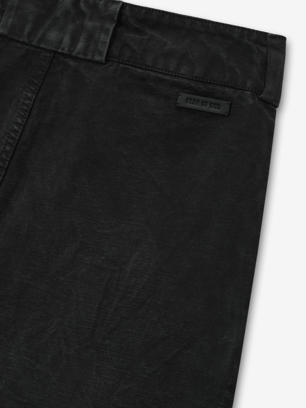 close-up of black washed canvas utility pant waistband with Fear of God branded patch detail