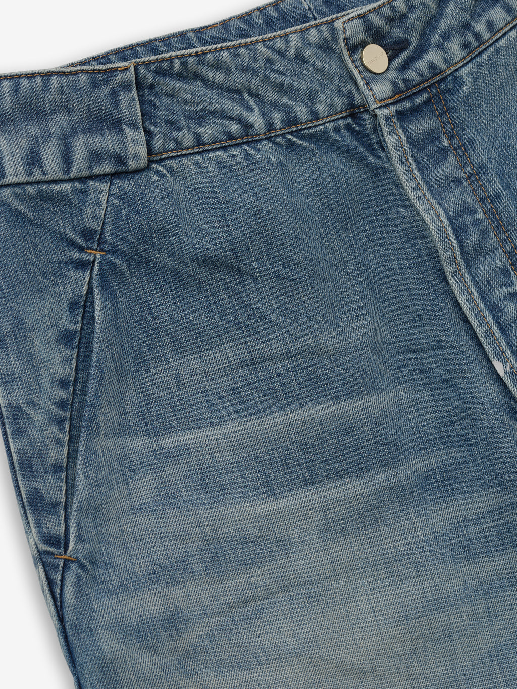 close-up of medium vintage wash denim utility pants front waistband with metal button and side seam pocket details