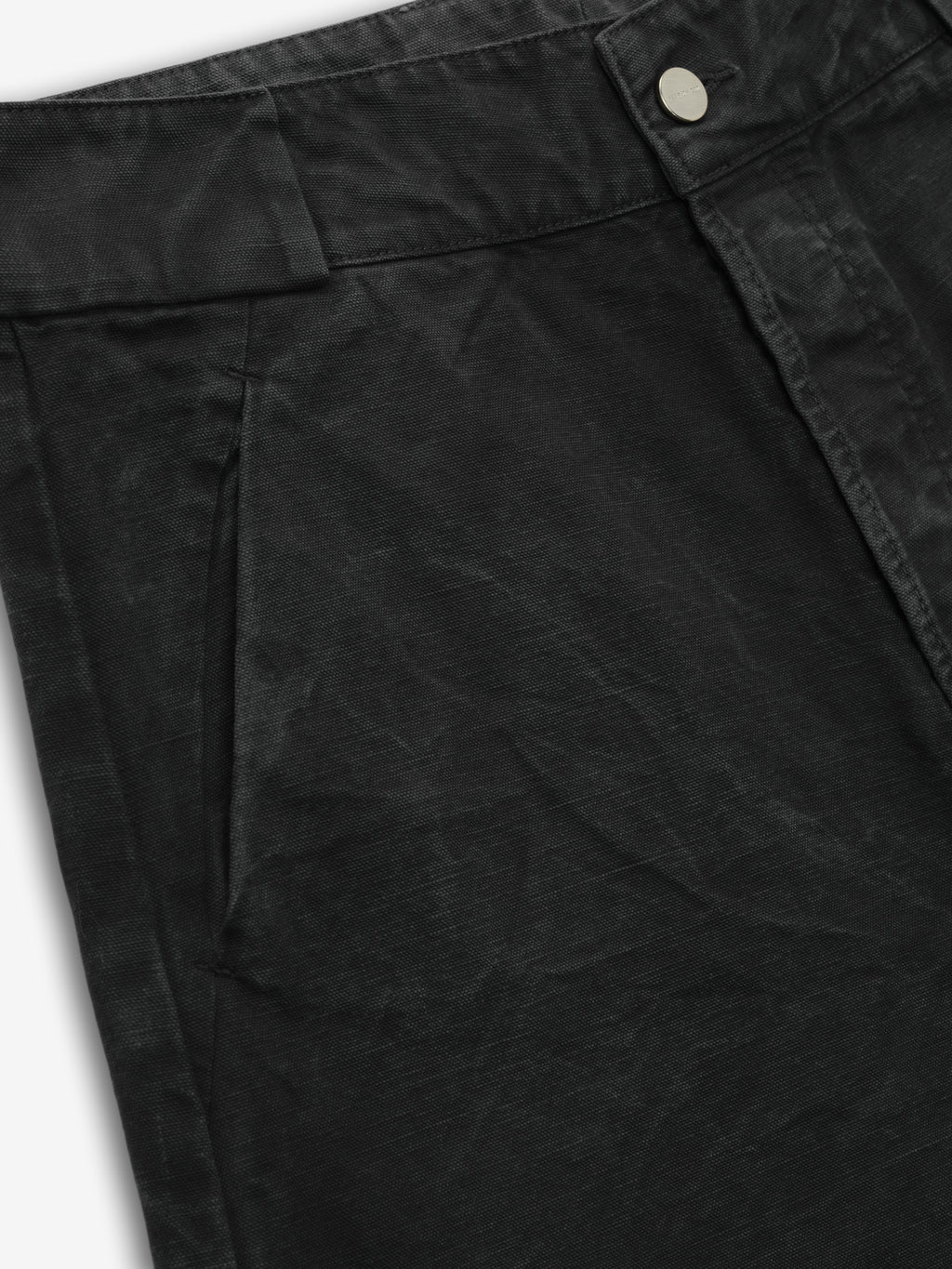 close-up detail of front pocket and waistband button on black washed cotton canvas utility shorts