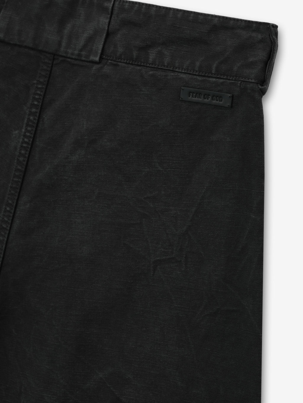 close-up of black washed cotton canvas utility shorts showing waistband and Fear of God branded leather patch