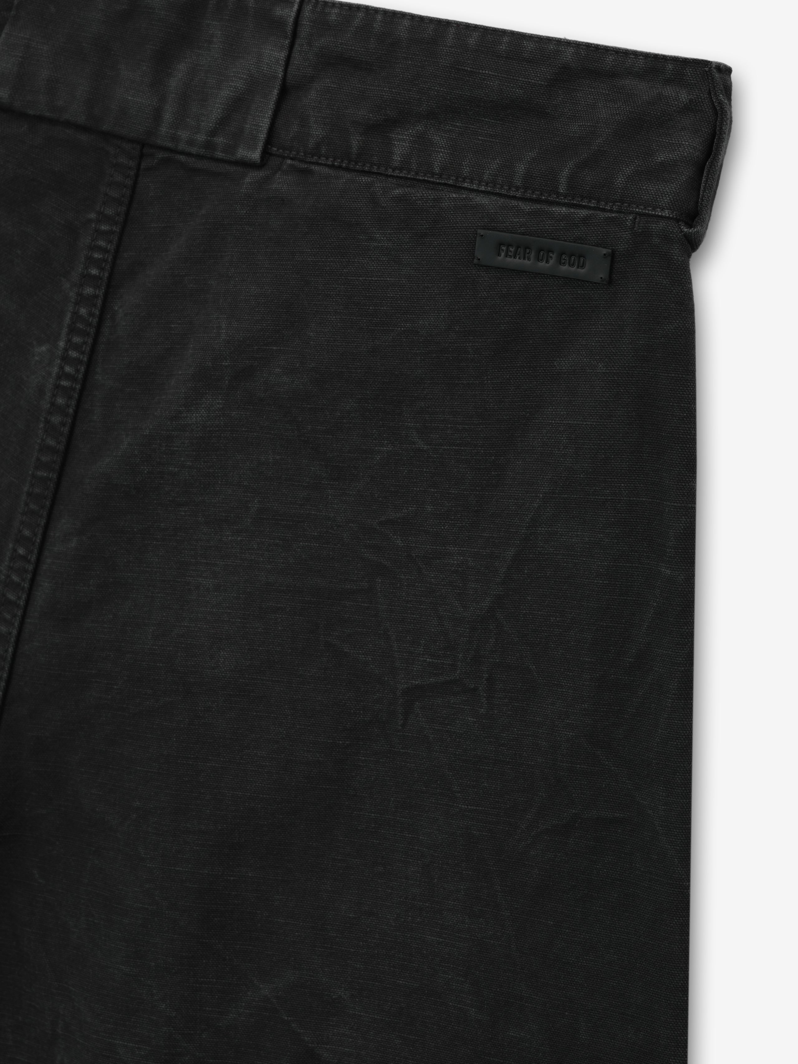 close-up of black washed cotton canvas utility shorts showing waistband and Fear of God branded leather patch