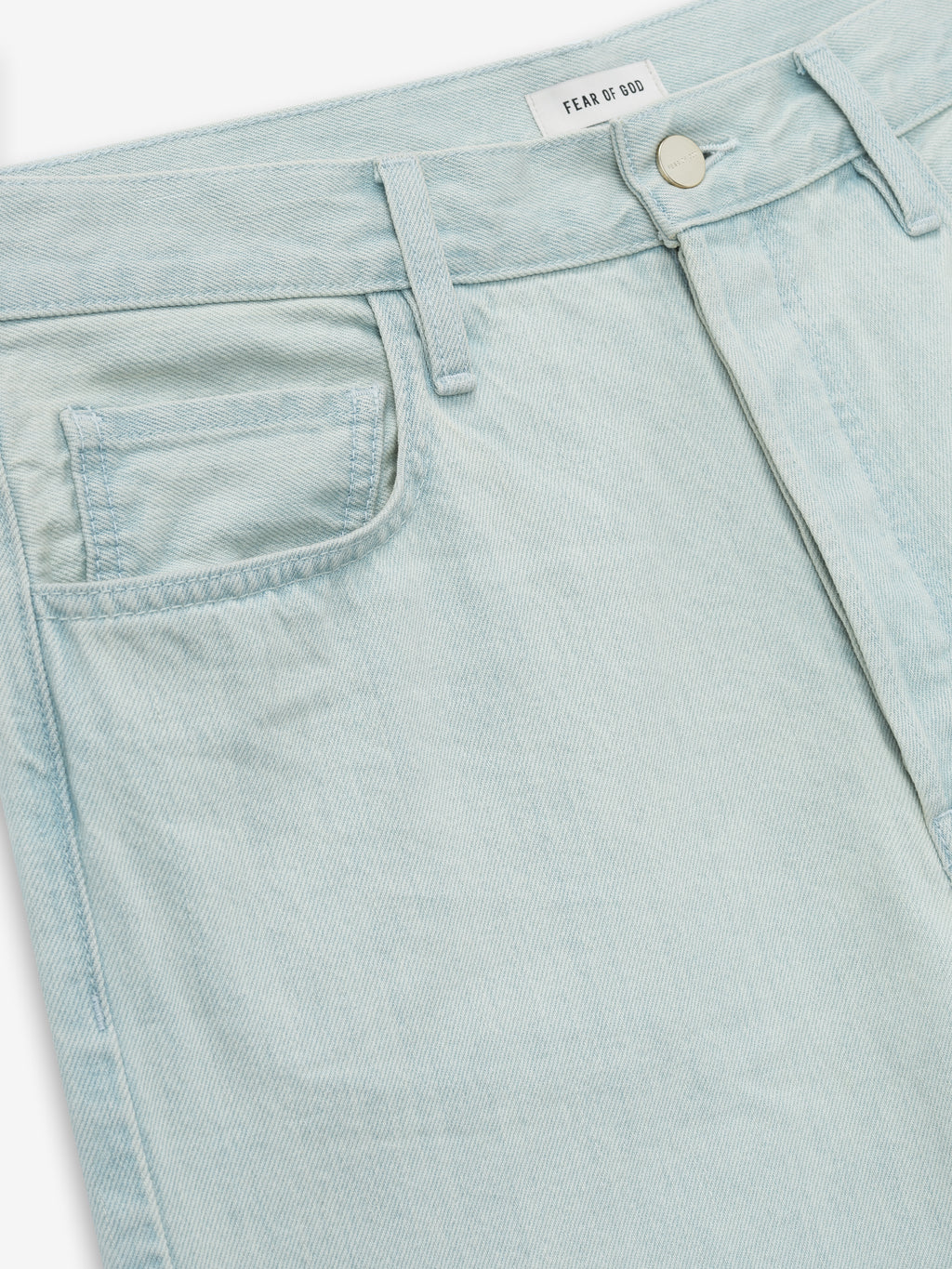 close-up of light bleached denim jeans front with coin pocket, belt loops, and silver button closure
