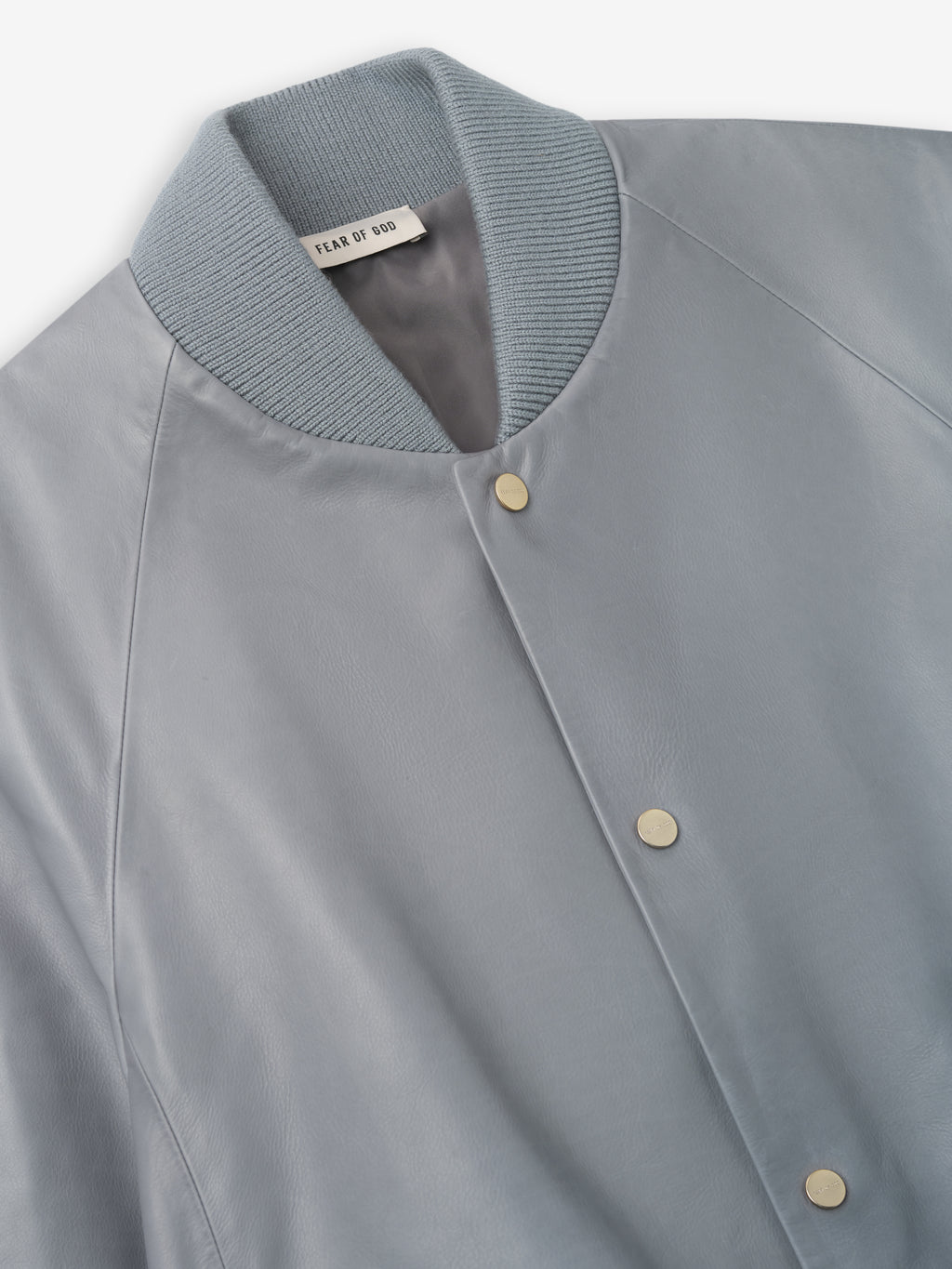 close-up of light blue full grain calfskin bomber jacket with rib knit collar and snap button closure