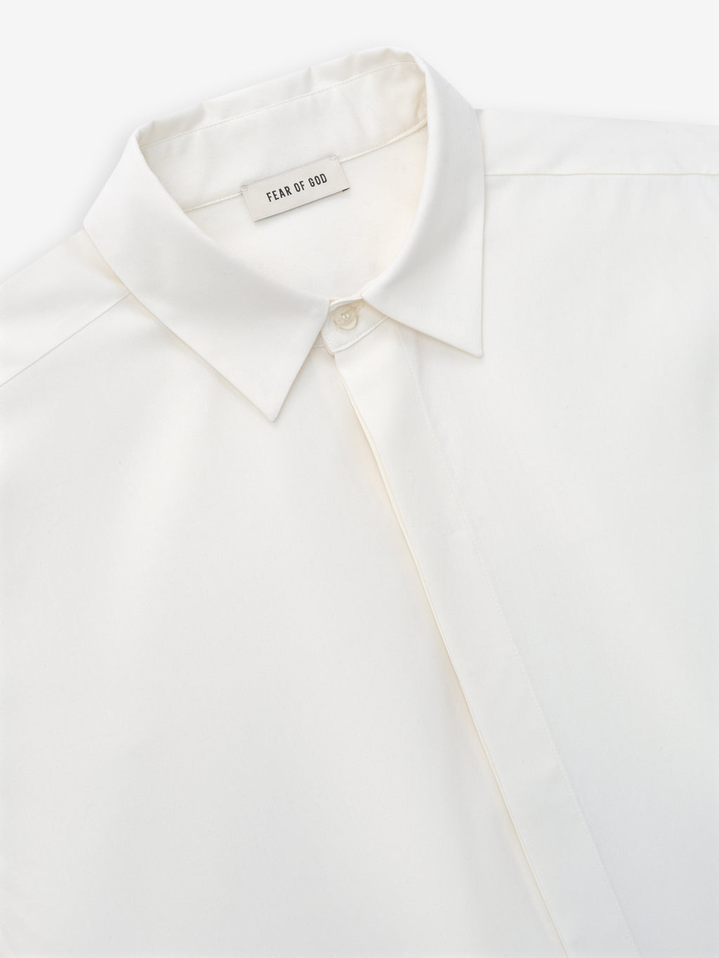 close-up of white cotton wool oxford classic shirt collar with covered button placket and Fear of God label