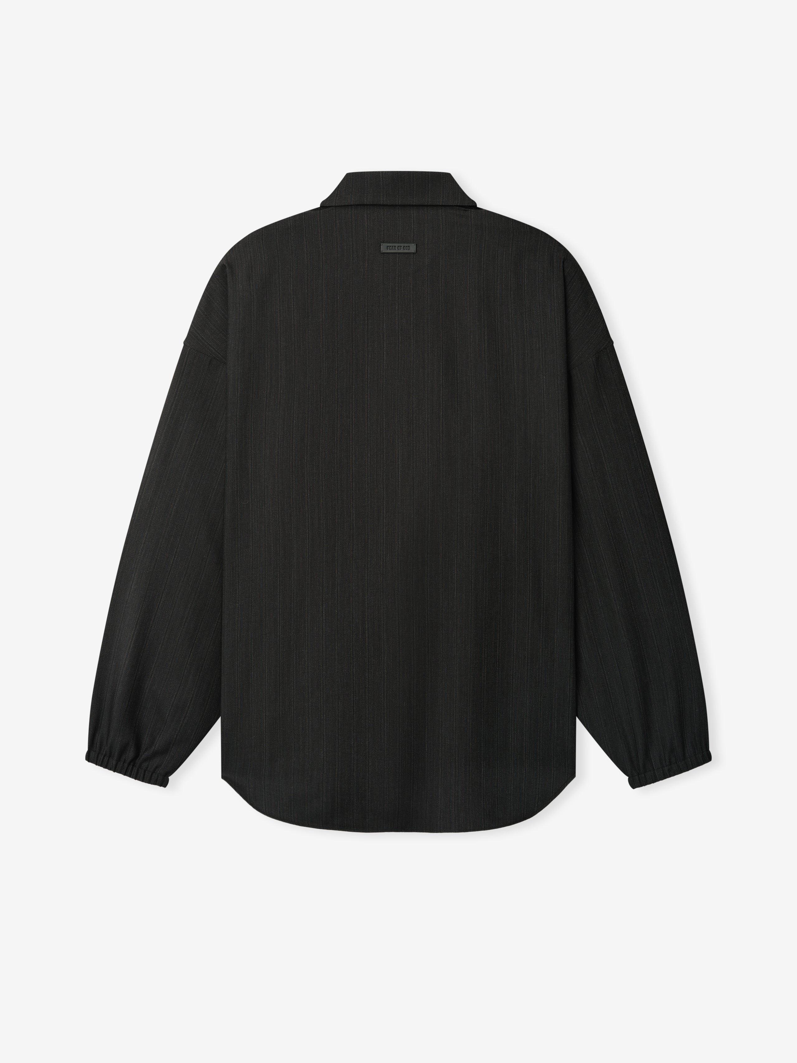 back view of relaxed fit striped wool shirt with elasticated cuffs and curved hem on plain white background