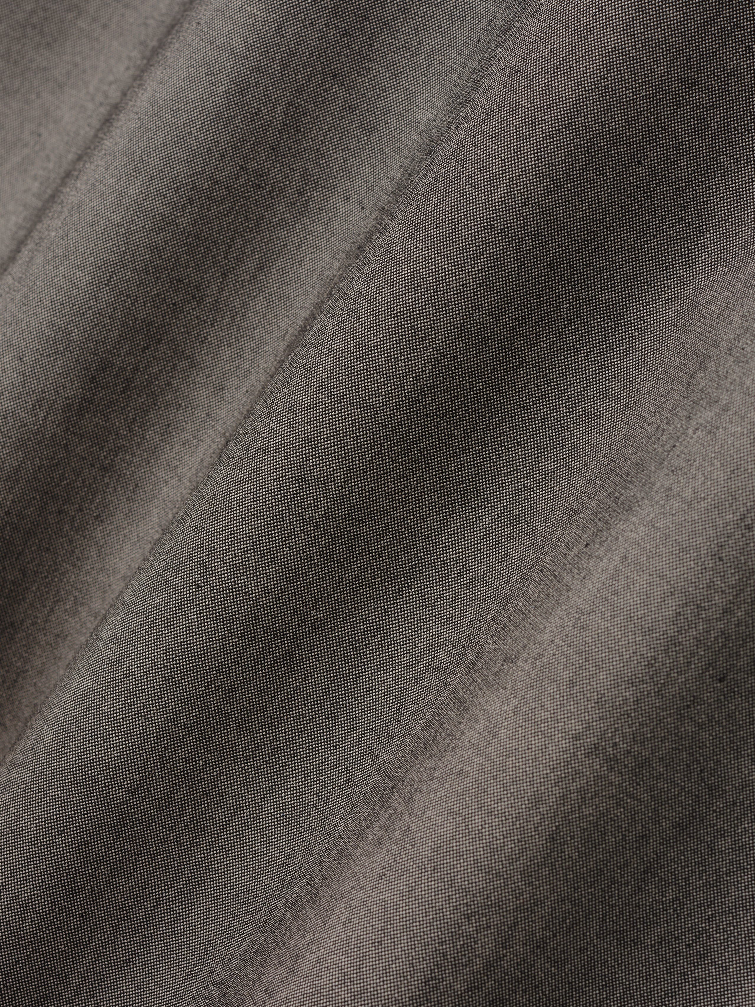 close-up texture of muted taupe cotton-wool oxford fabric with subtle weave and soft drape