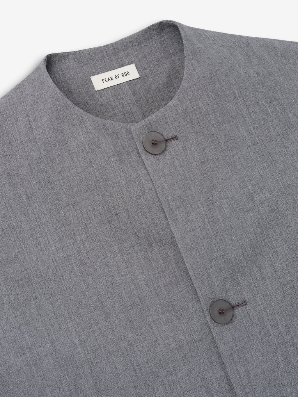 close-up of grey washed virgin wool-linen collarless sport jacket with minimal button closure and smooth texture