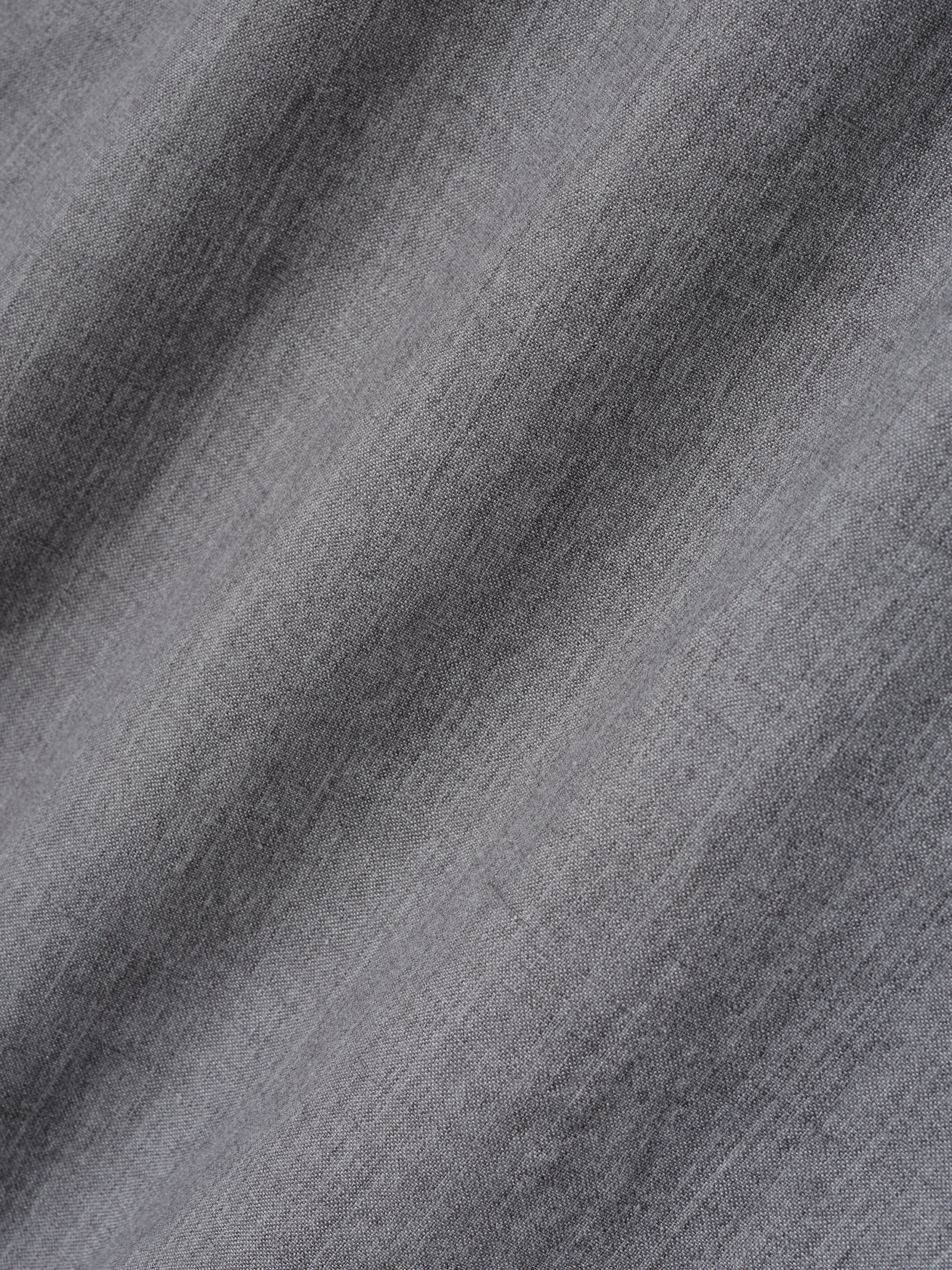 close-up of light grey washed virgin wool-linen fabric with soft texture and subtle woven details