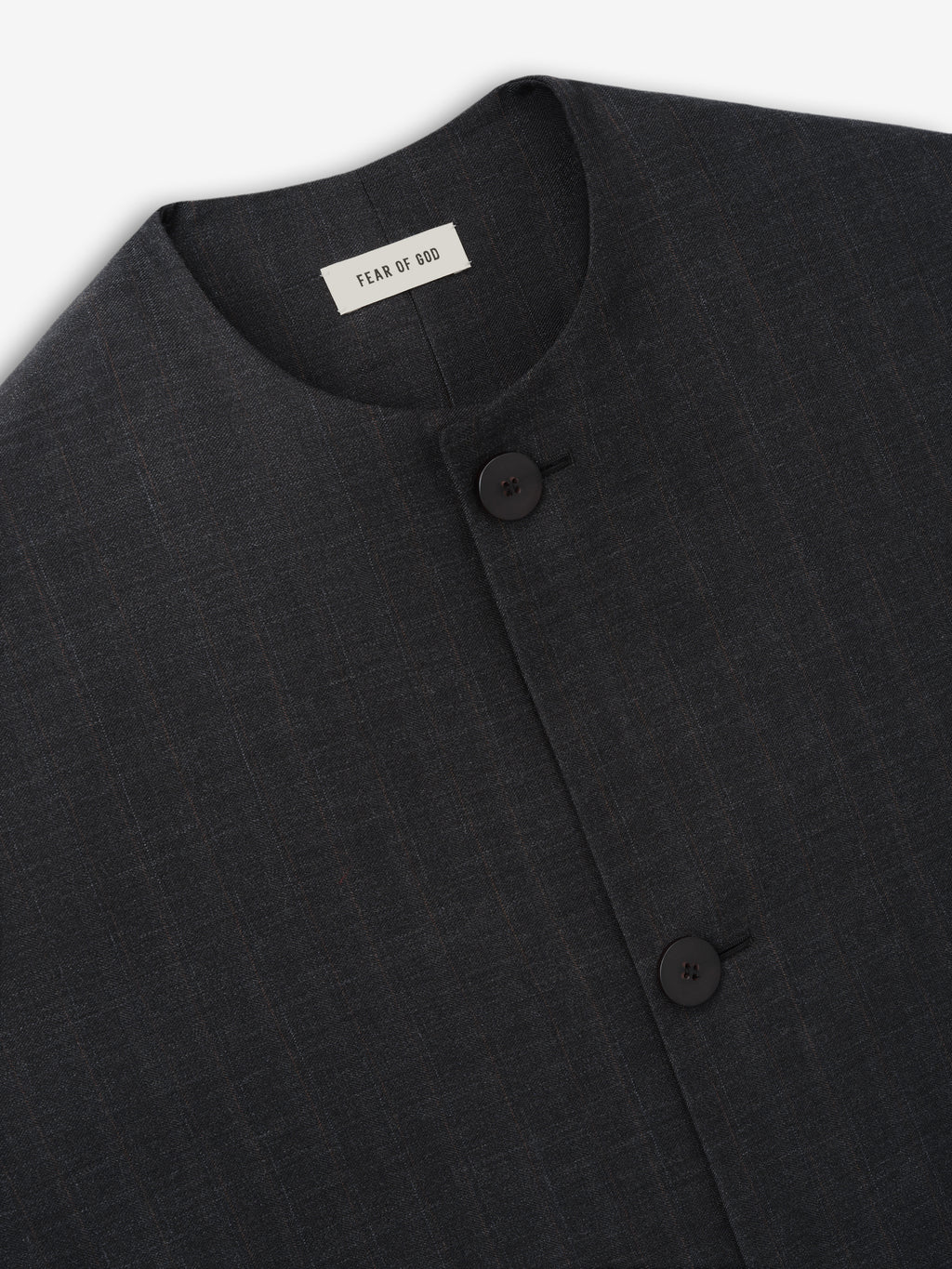 Close-up of dark charcoal textured fabric jacket with round neckline and two black buttons on front panel