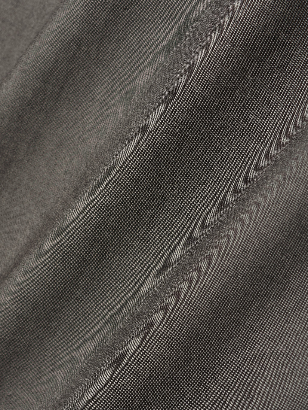 detailed view of textured cotton-wool oxford fabric with soft drape in muted grey tone