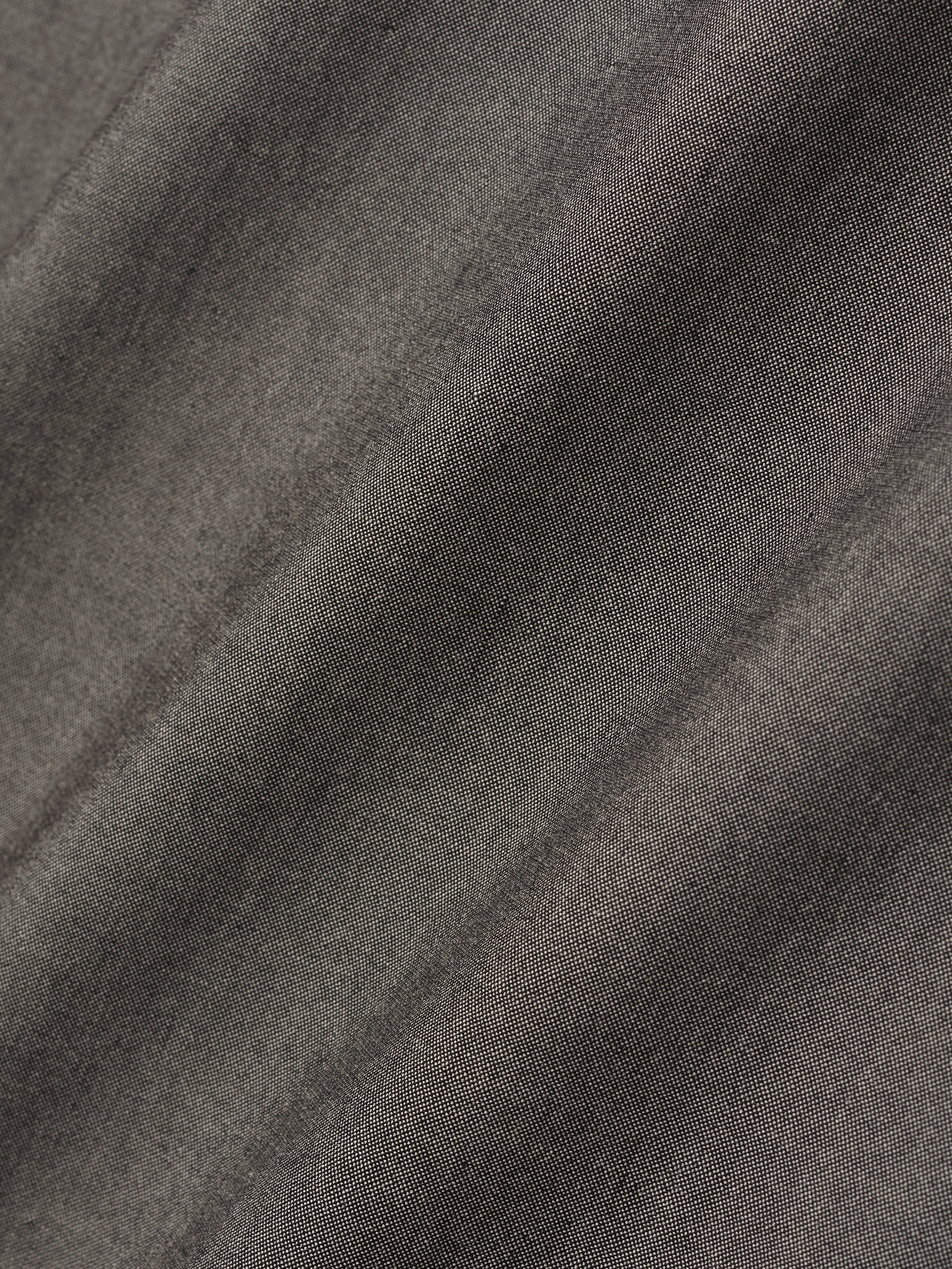 detailed view of textured cotton-wool oxford fabric with soft drape in muted grey tone