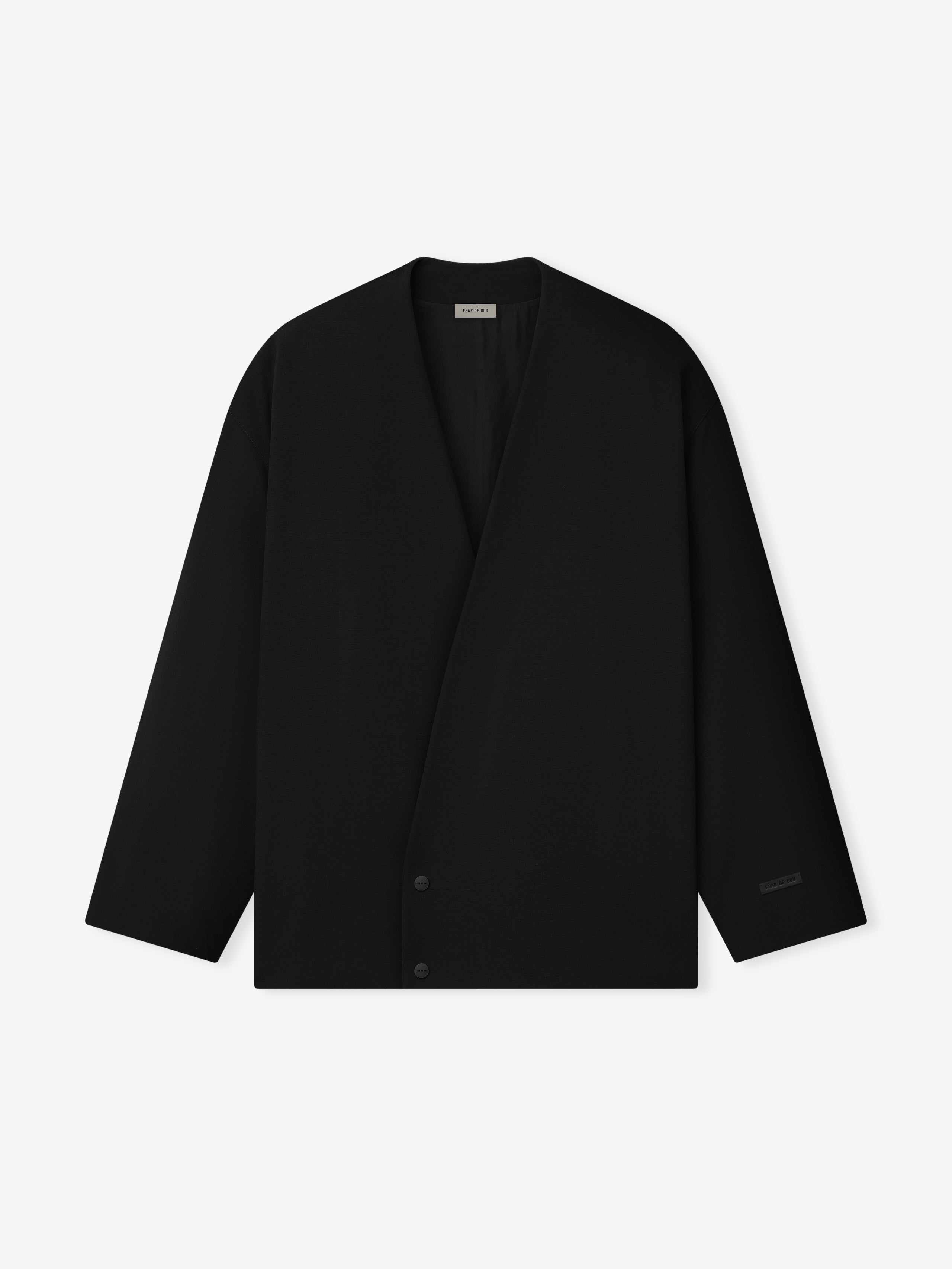 black lapelless cropped jacket in lightweight wool canvas with metal snap button closure and relaxed fit silhouette