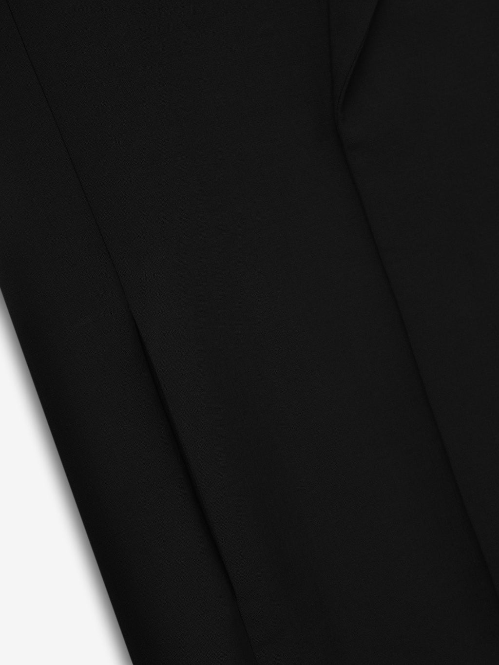 close-up of smooth black double-weave virgin wool fabric showcasing fine texture and tailored seam detail