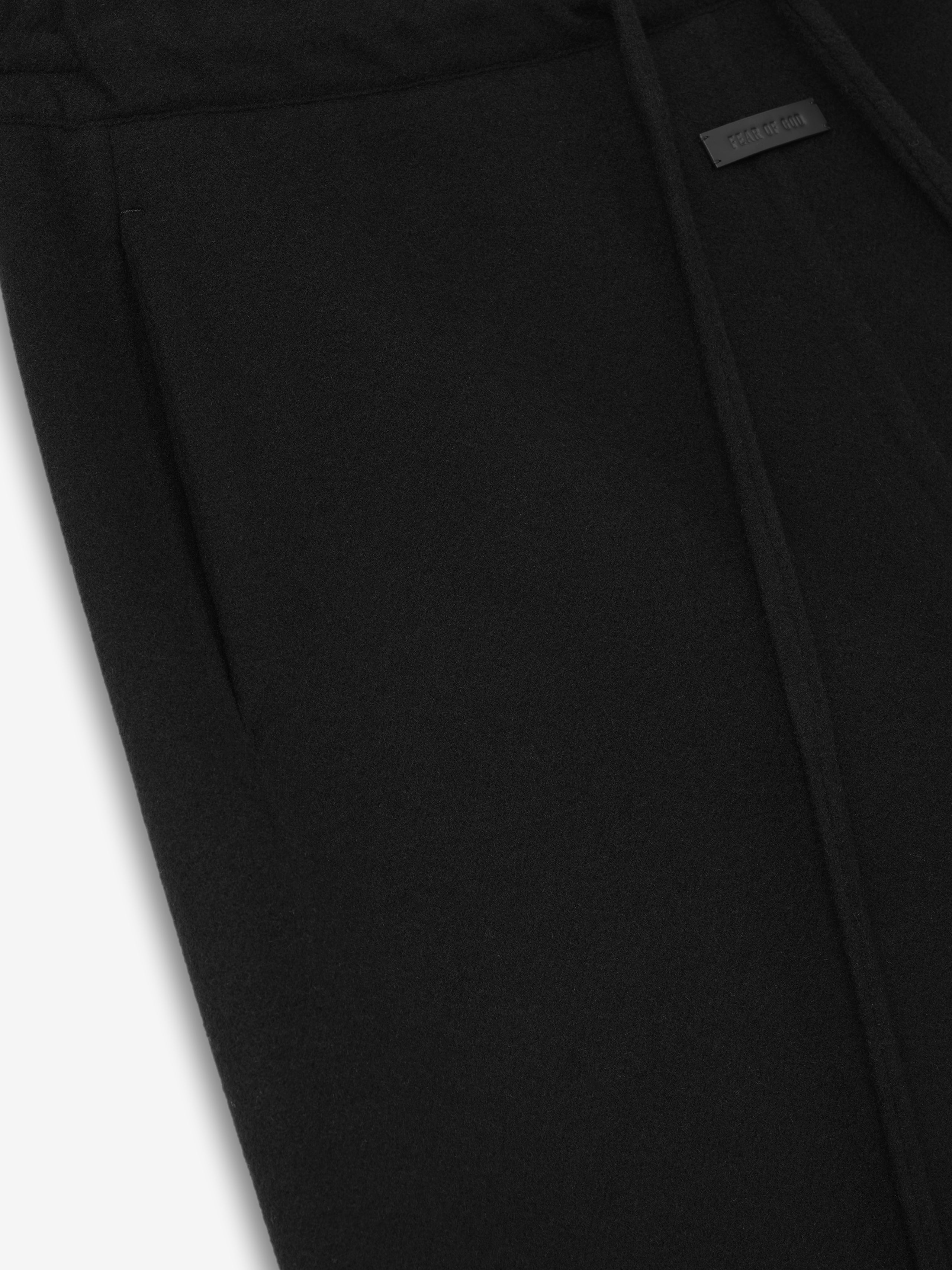 close-up of black double face wool cashmere flared pants showing waistband and side pocket detail