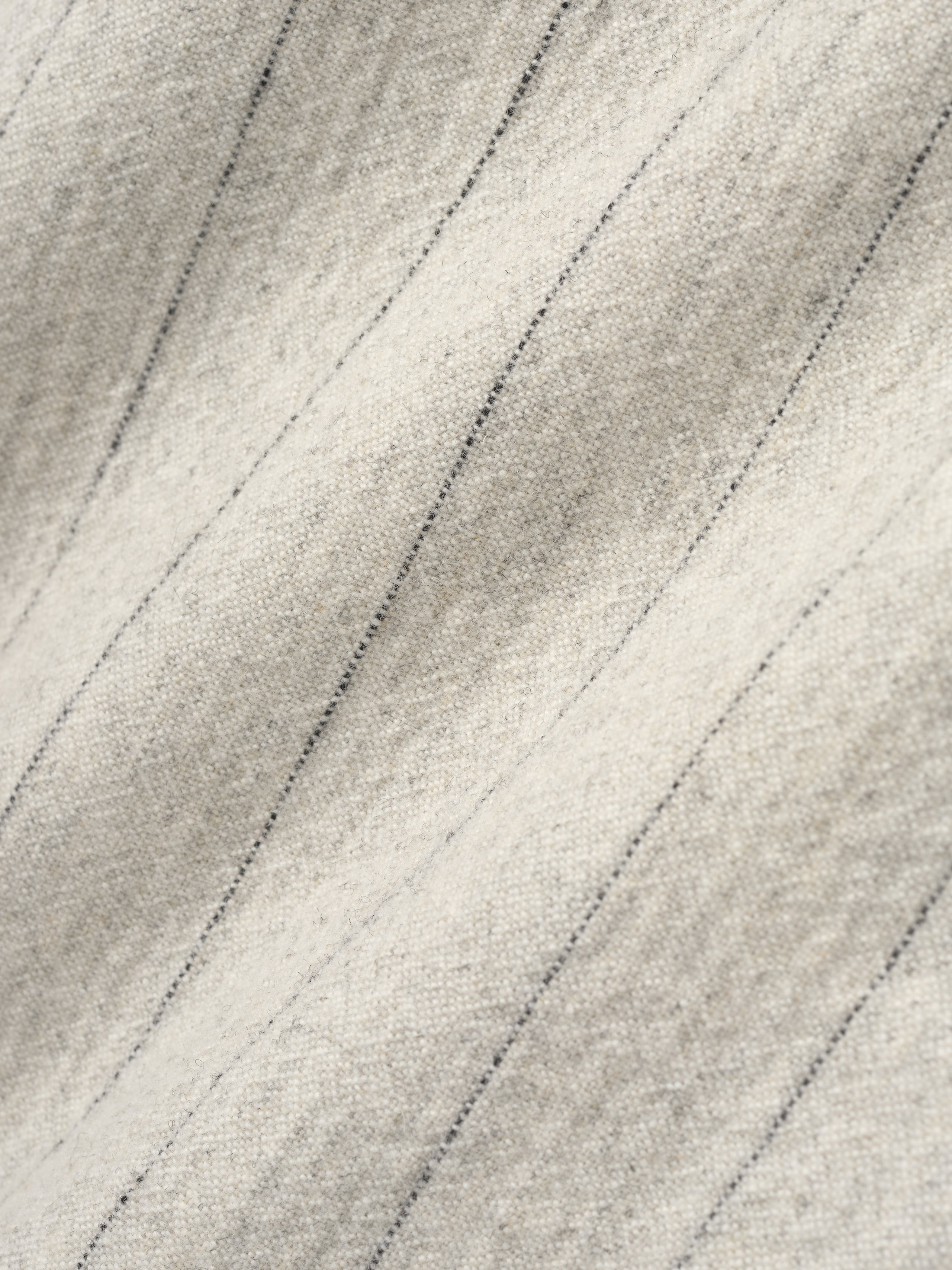 close-up of pinstriped double face wool nylon fabric in light beige with fine vertical lines and soft texture