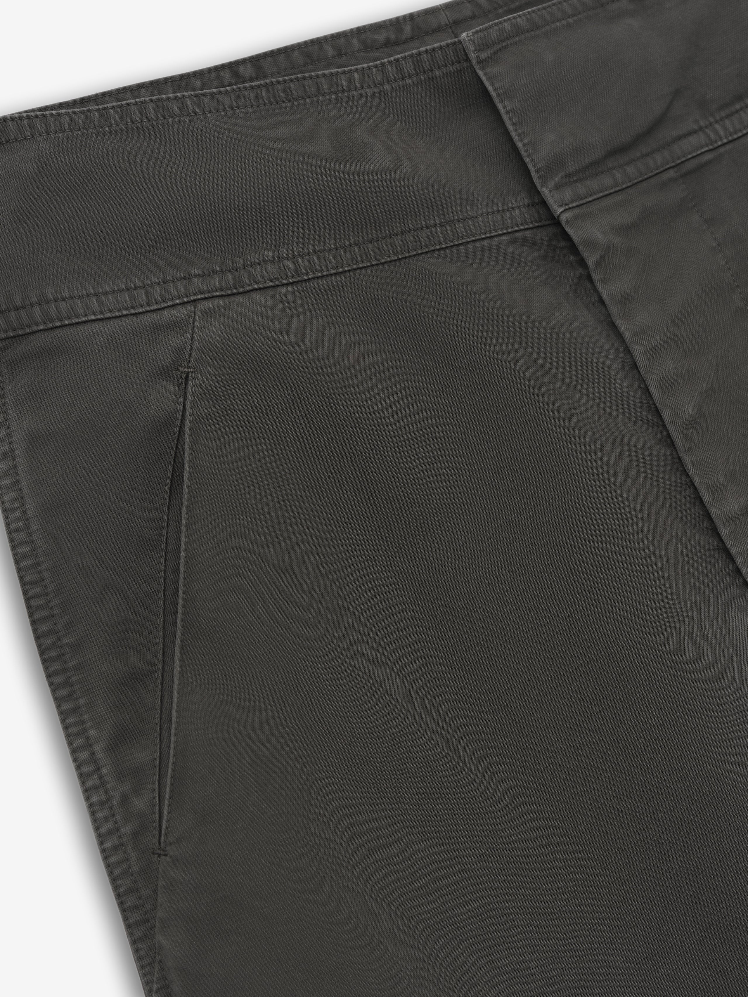 close-up of dark garment dyed heavy double weave cotton casual pants with side seam pocket and clean stitching detail