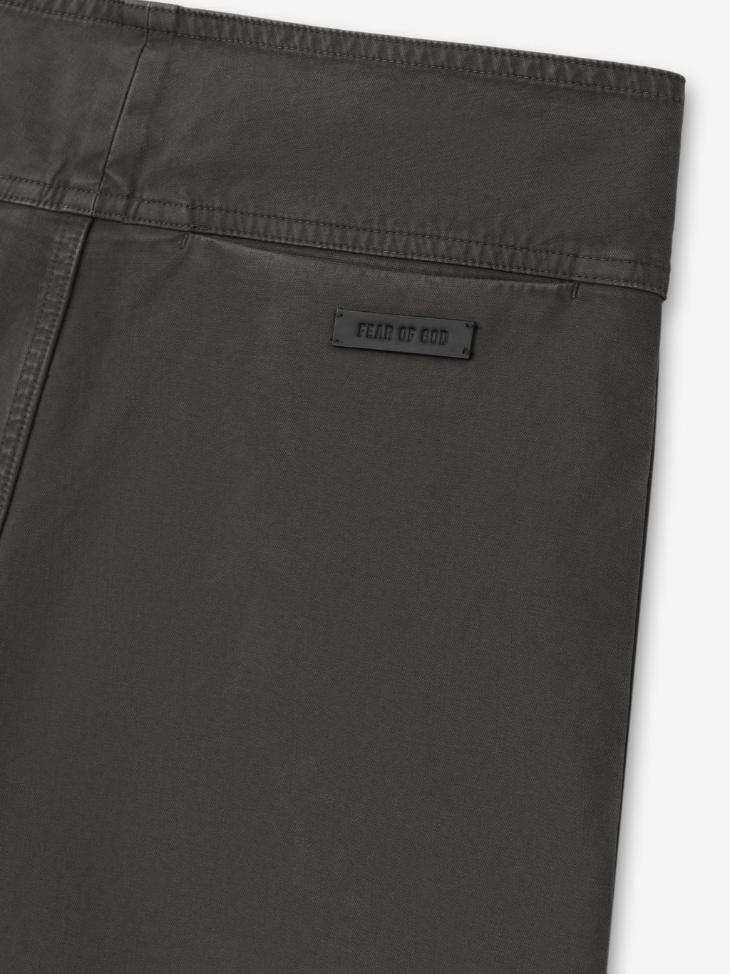 close-up of dark garment dyed heavy double weave cotton pant back with subtle brand label and clean waistband stitching