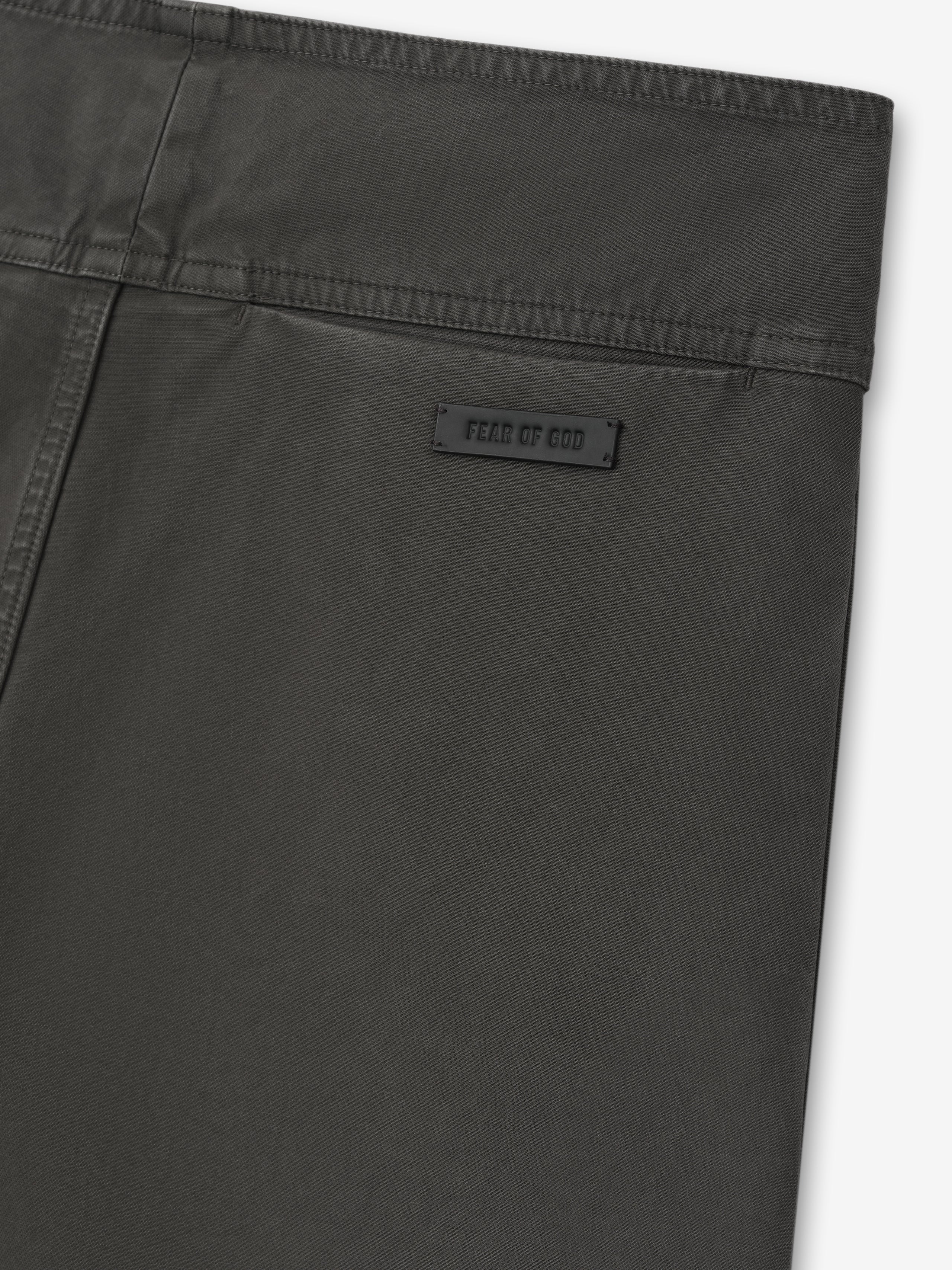 close-up of dark garment dyed heavy double weave cotton pant back with subtle brand label and clean waistband stitching