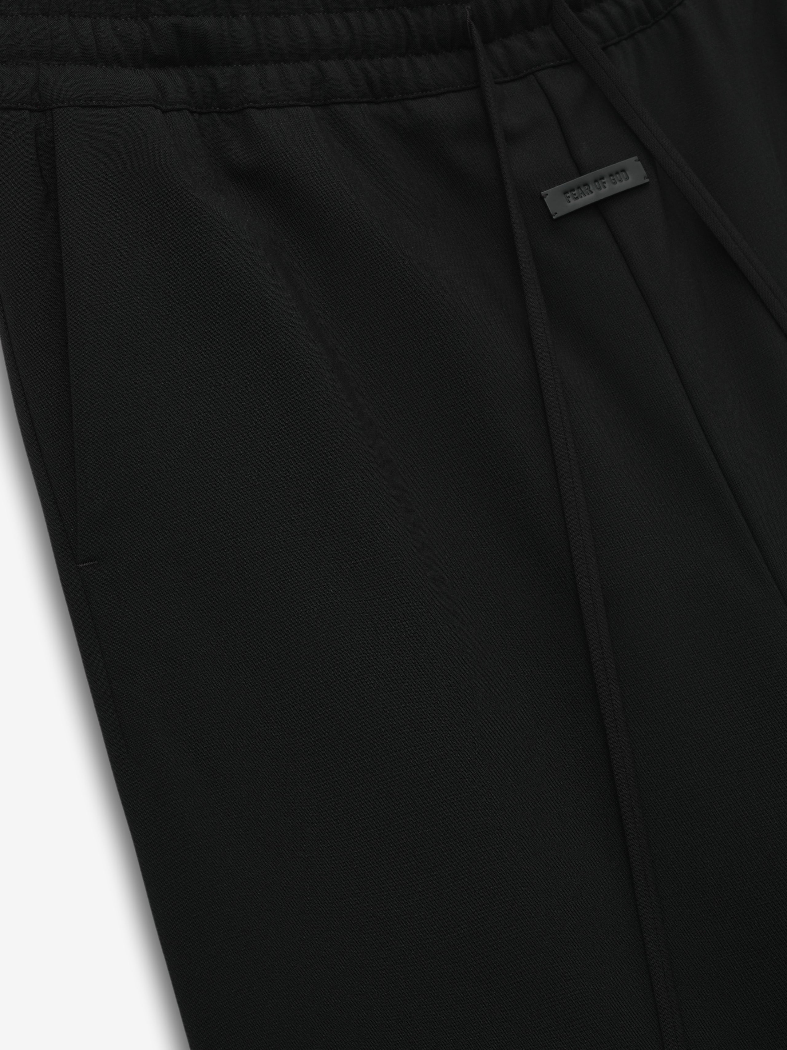 close-up of black double-weave virgin wool wide leg pants with elastic waistband and drawstring closure detail