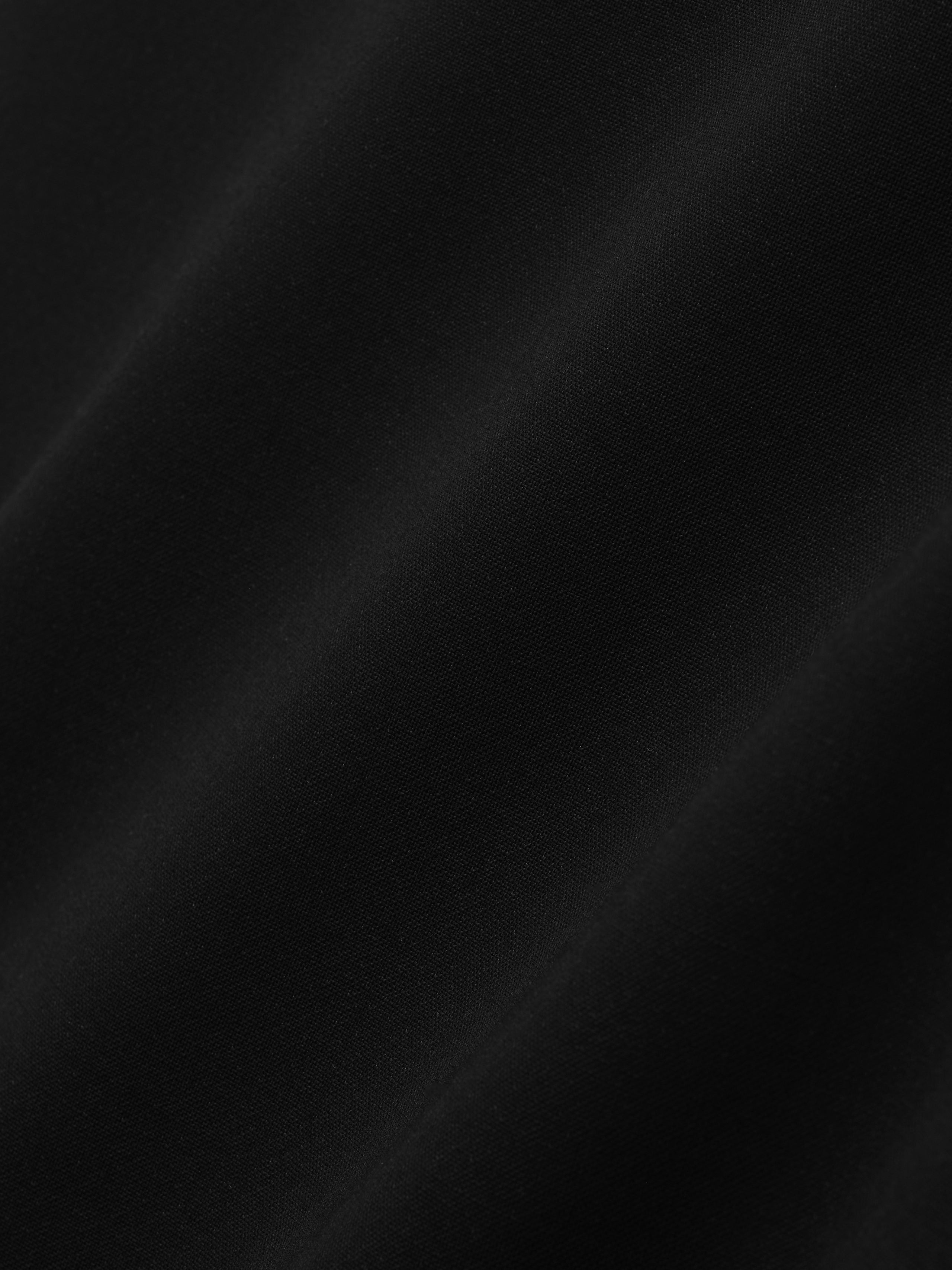 close-up of smooth black double-weave virgin wool fabric with matte finish and soft drape