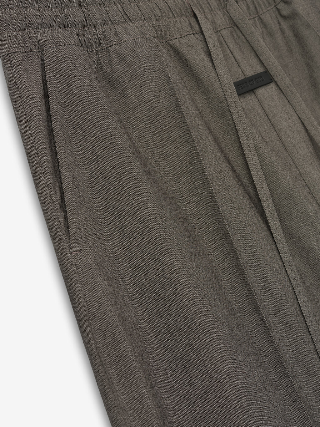 close-up of taupe cotton wool oxford wide-leg pants with elastic waistband, side pocket, and drawstring detail