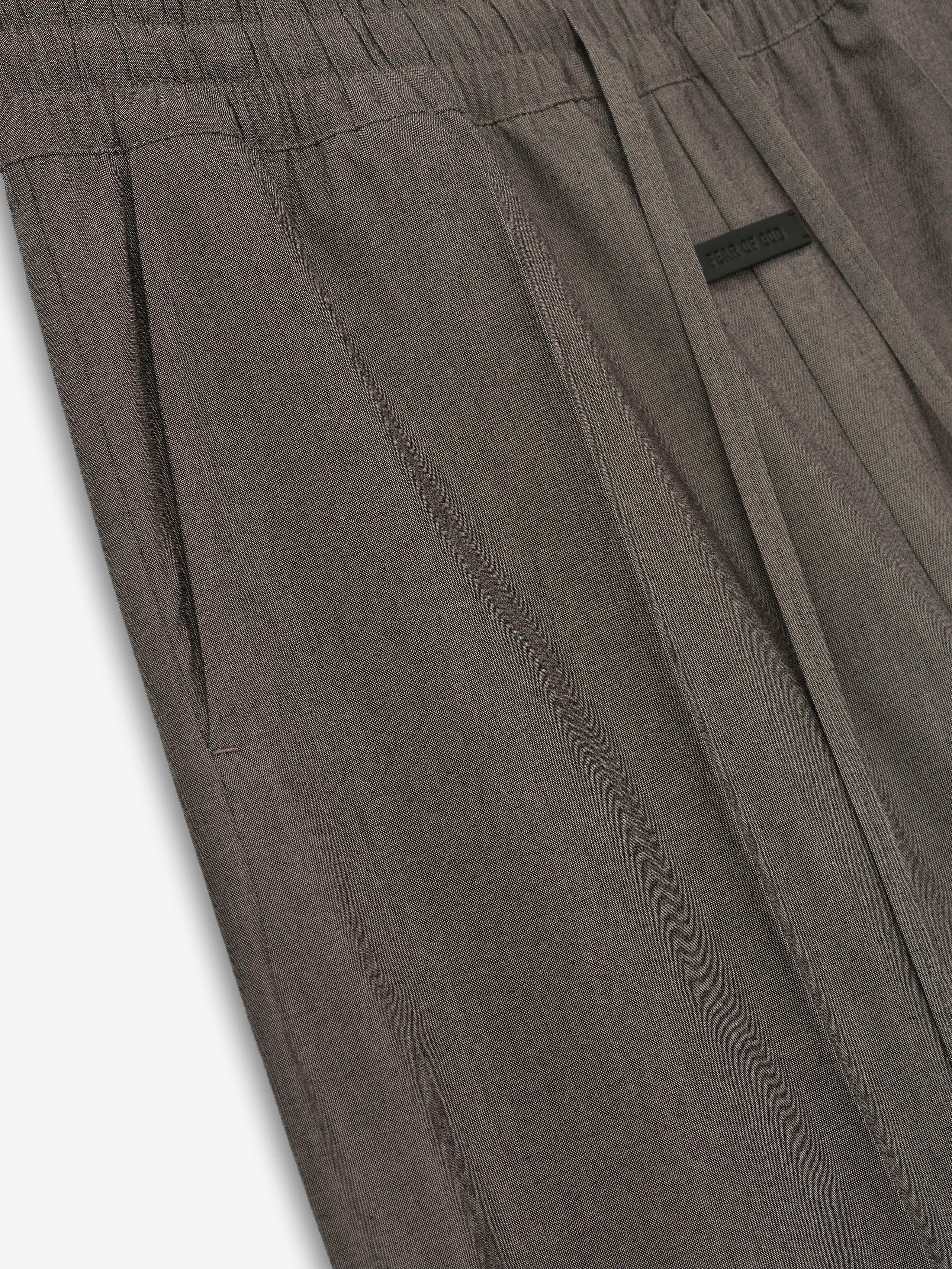 close-up of taupe cotton wool oxford wide-leg pants with elastic waistband, side pocket, and drawstring detail