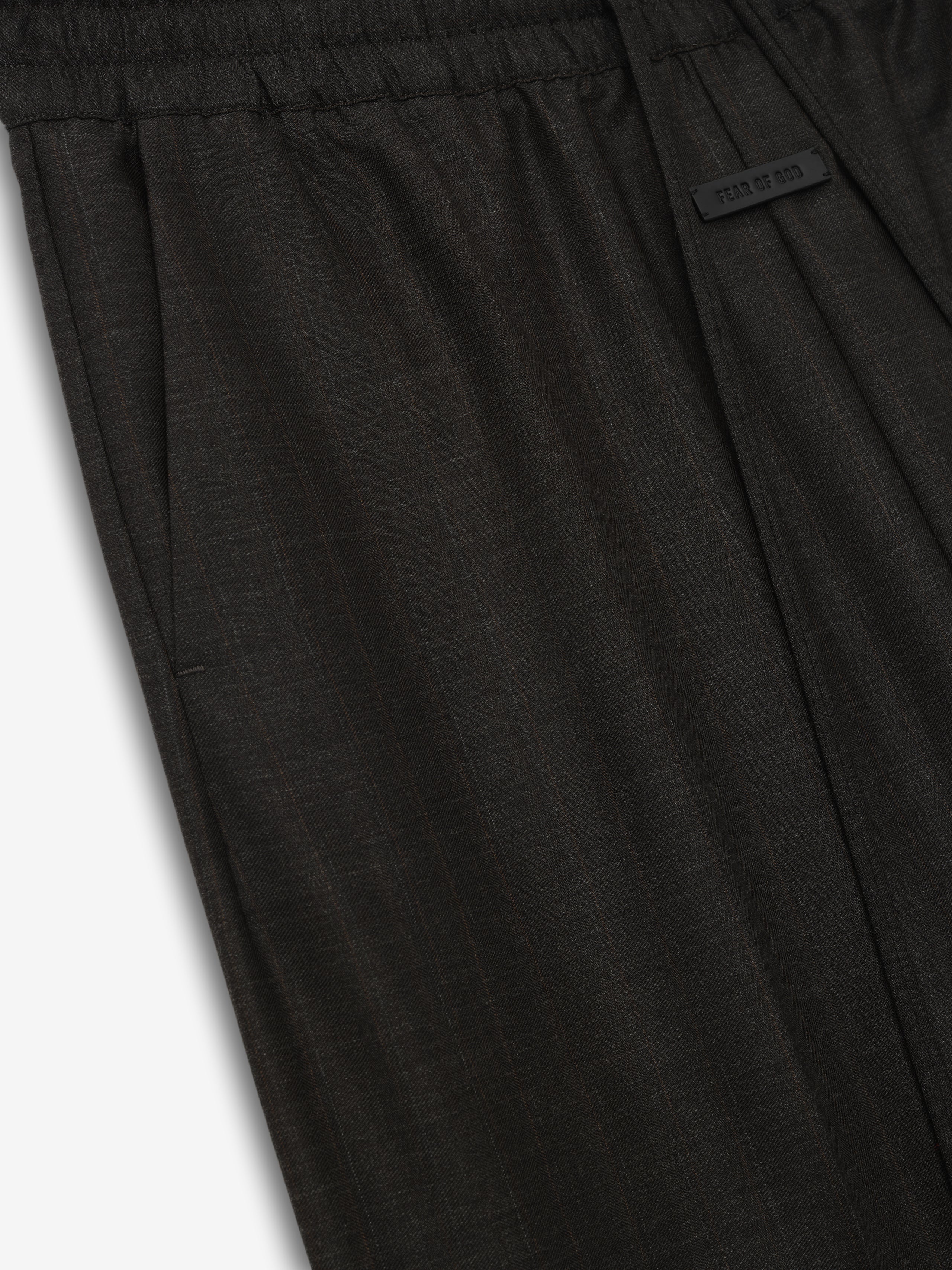 dark charcoal wide-leg wool pants with elastic waistband and adjustable drawstring featuring subtle texture and side pockets detail