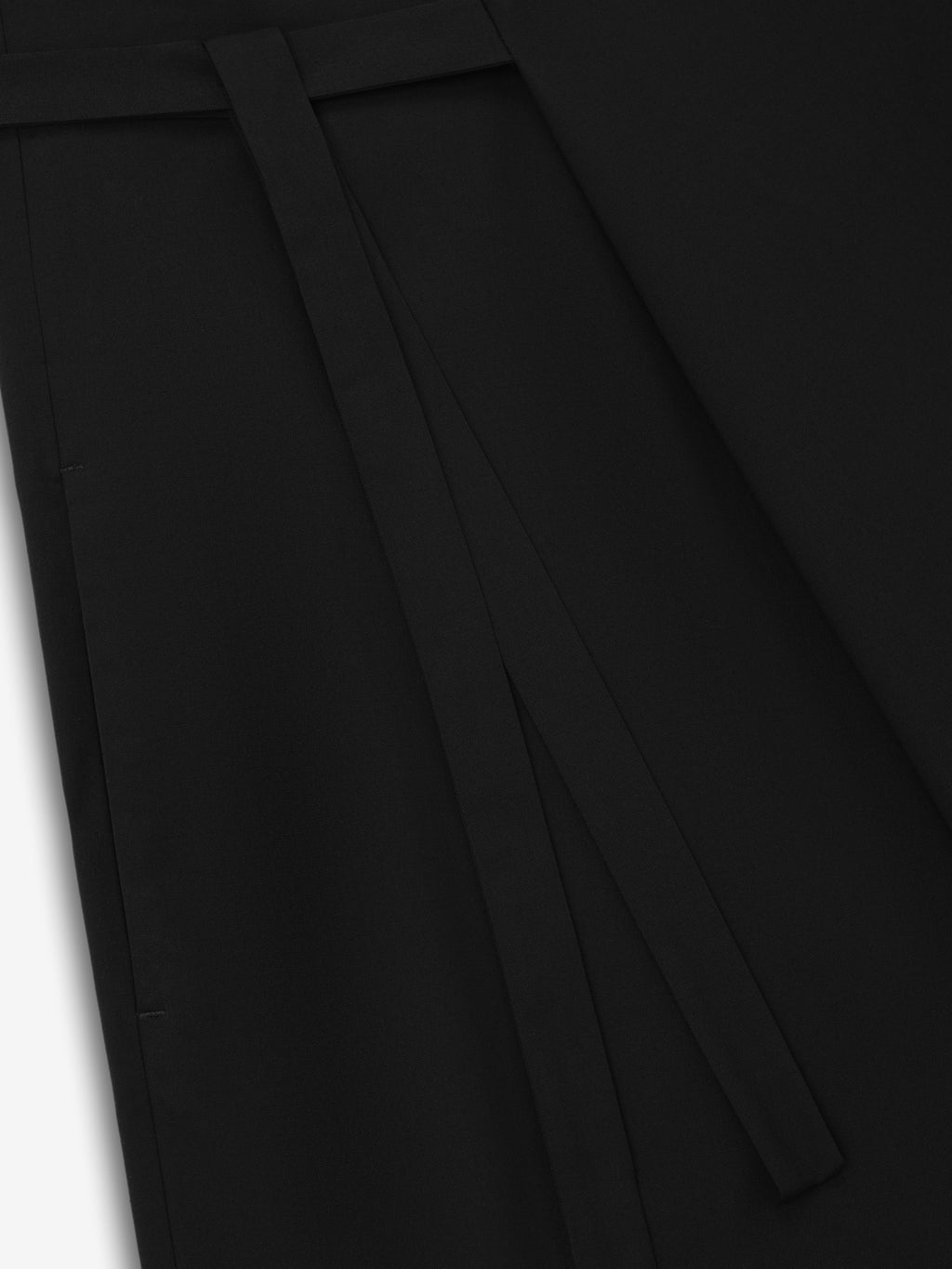 close-up of black low-rise wrap pants made from superfine lightweight wool canvas with belt tie detail