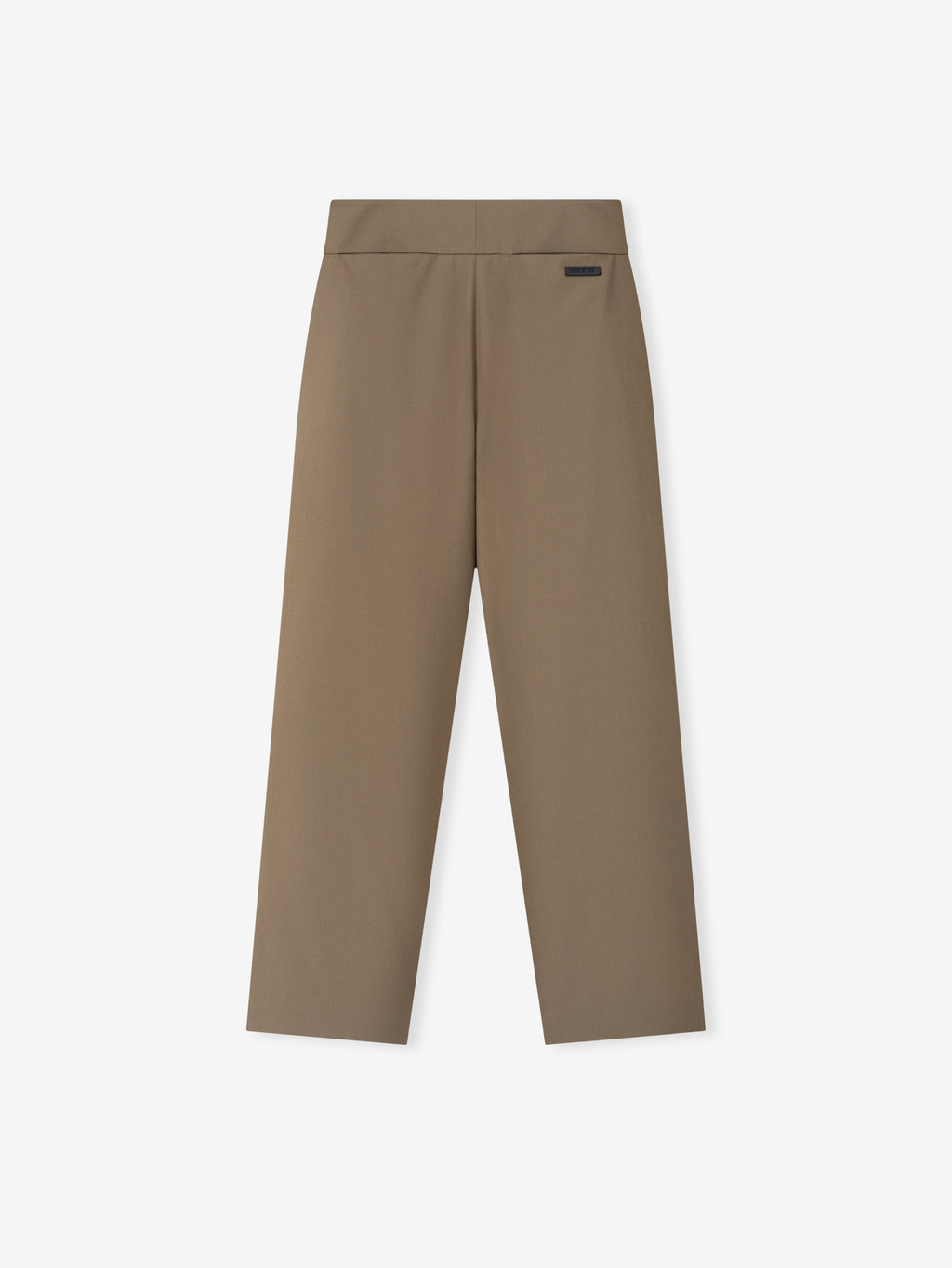 Flat-lay of clay-colored casual pants featuring a wide waistband and a small rectangular black label near the top edge