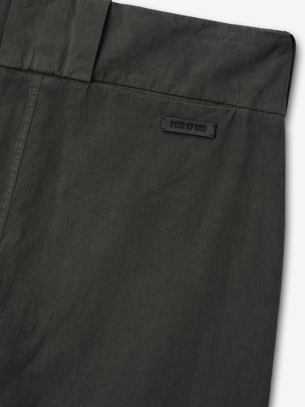 close-up of dark garment-dyed heavy cotton poplin casual short back waistband with Fear of God label detail
