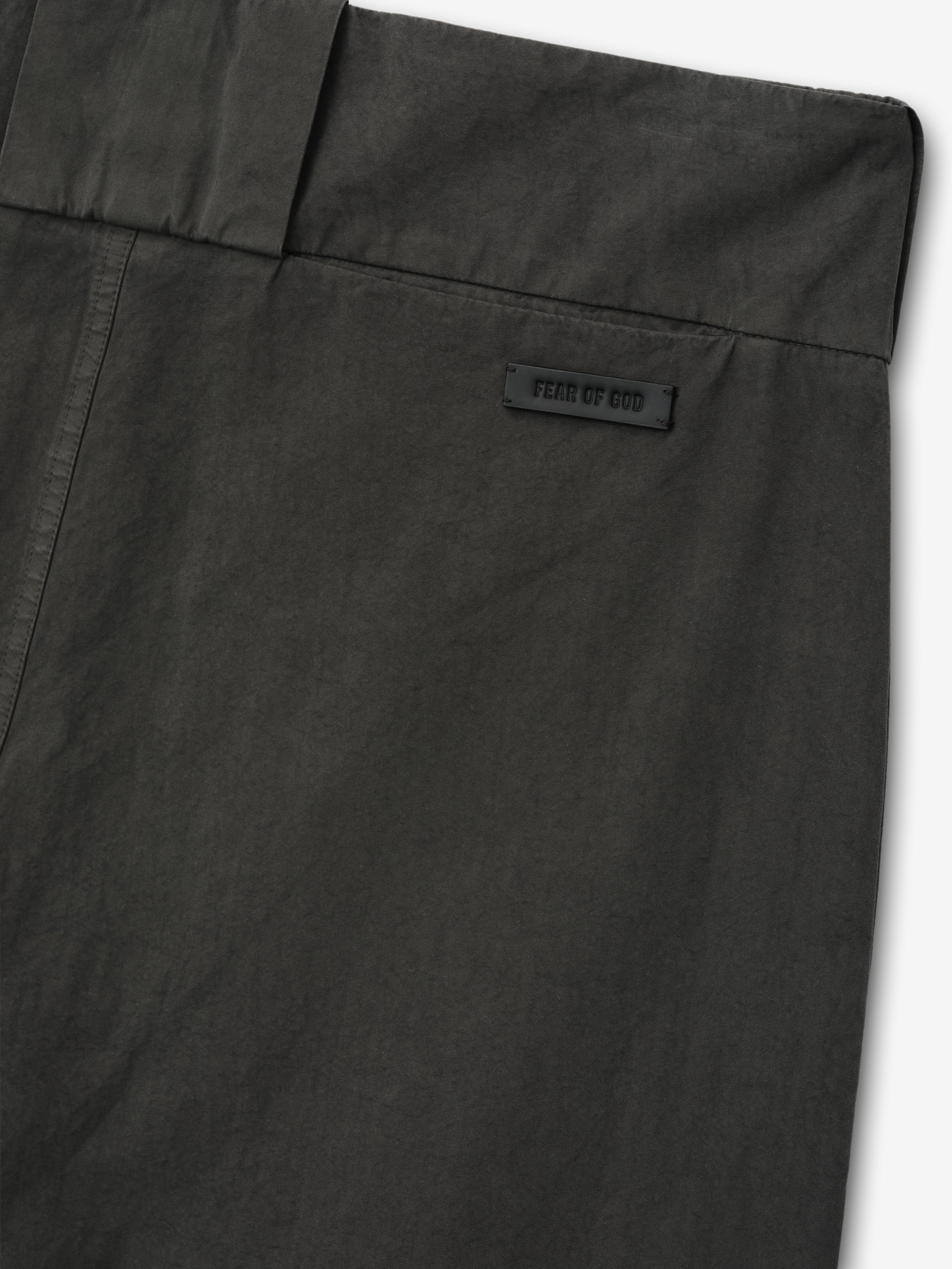 close-up of dark garment-dyed heavy cotton poplin casual short back waistband with Fear of God label detail
