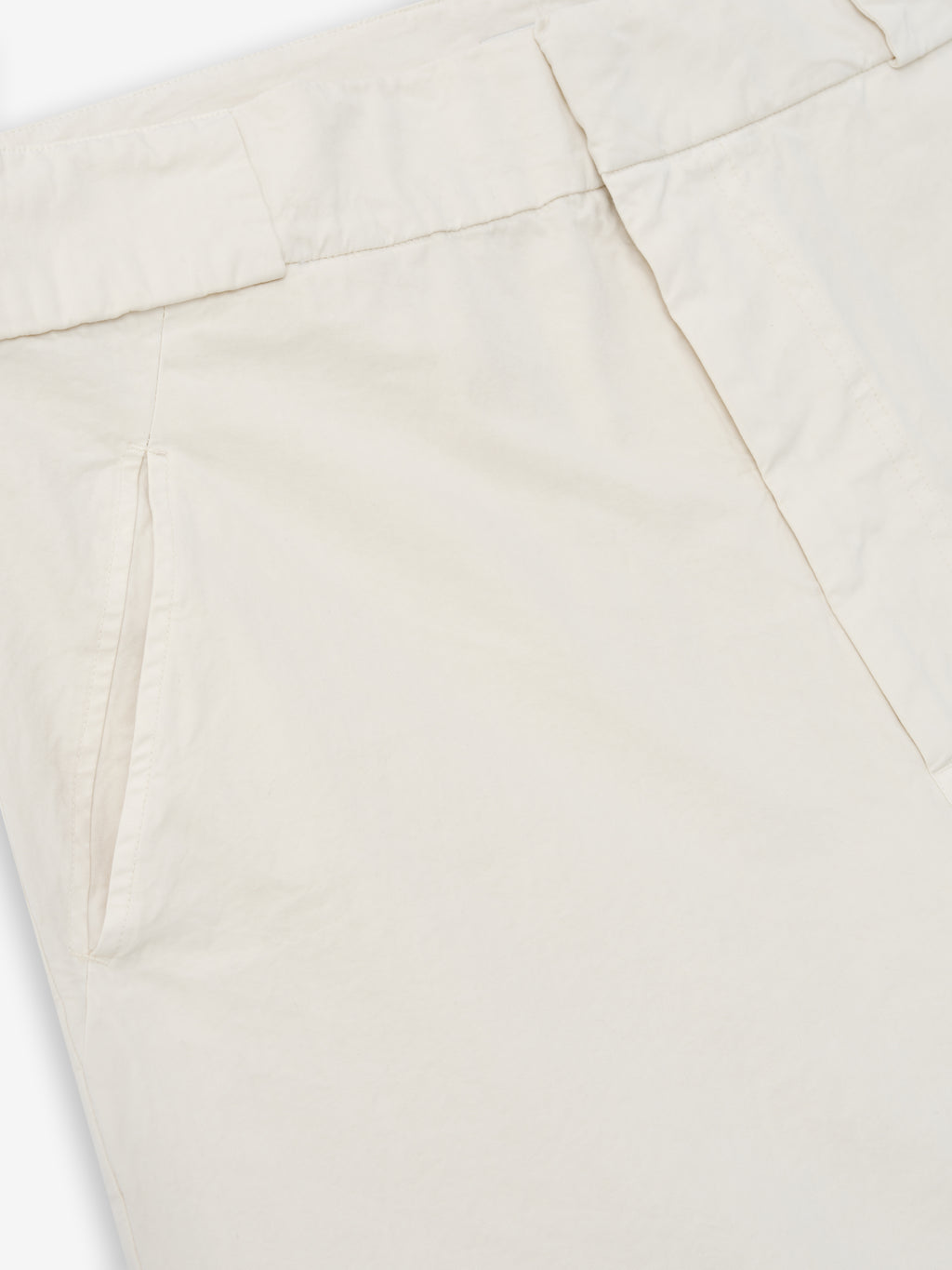close-up of off-white garment-dyed heavy cotton poplin casual shorts with slant front pocket and waistband detail