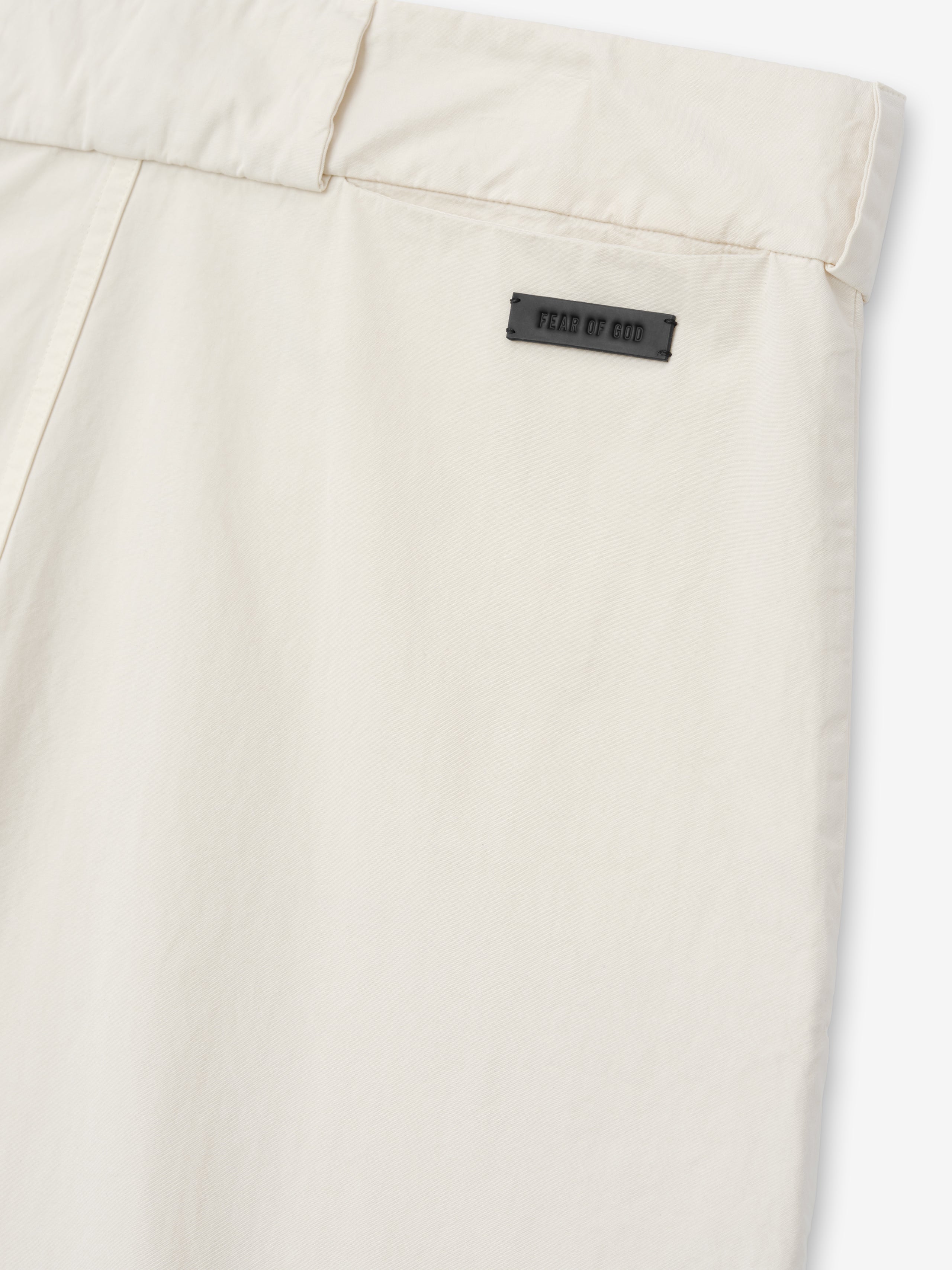 close-up of off-white garment-dyed heavy cotton poplin casual short back waistband with Fear of God label