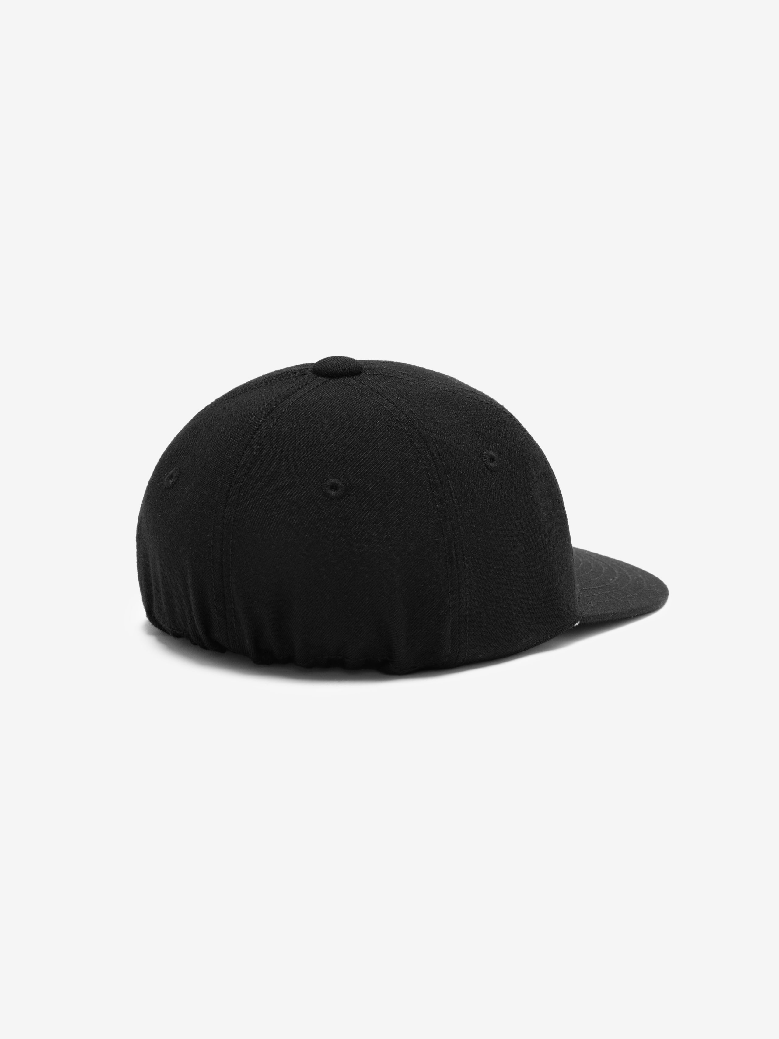 rear view of black textured wool baseball cap with elasticated back and stitched panel details