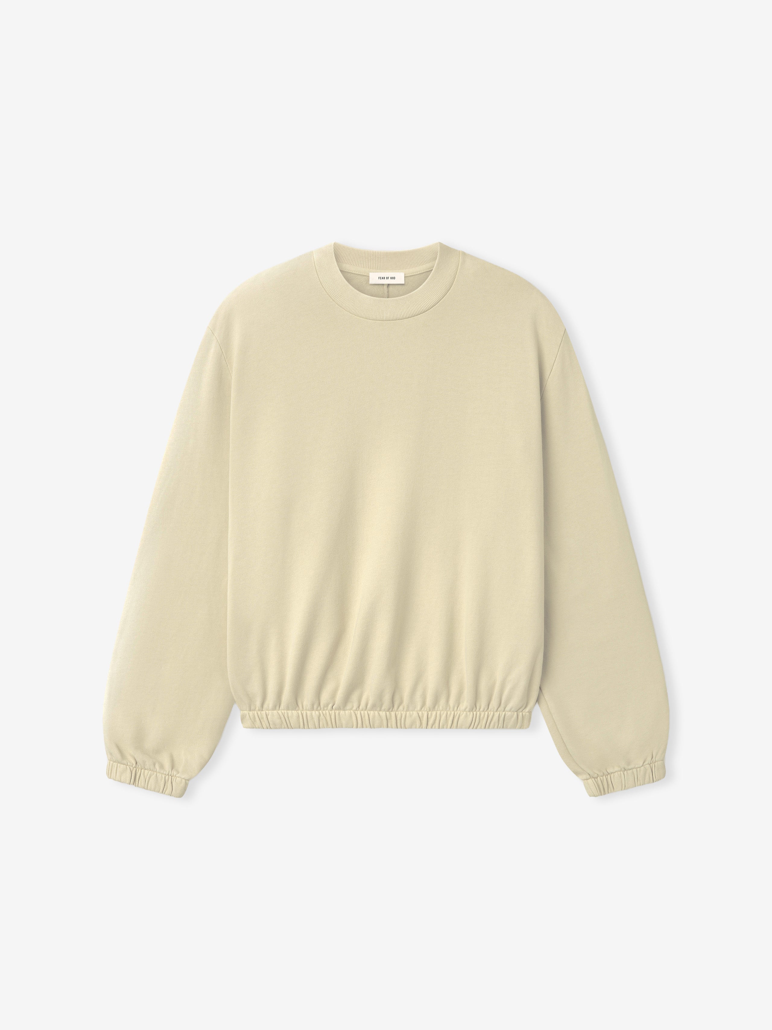 Off-white crewneck sweatshirt with long sleeves and elasticated cuffs and hem on plain background