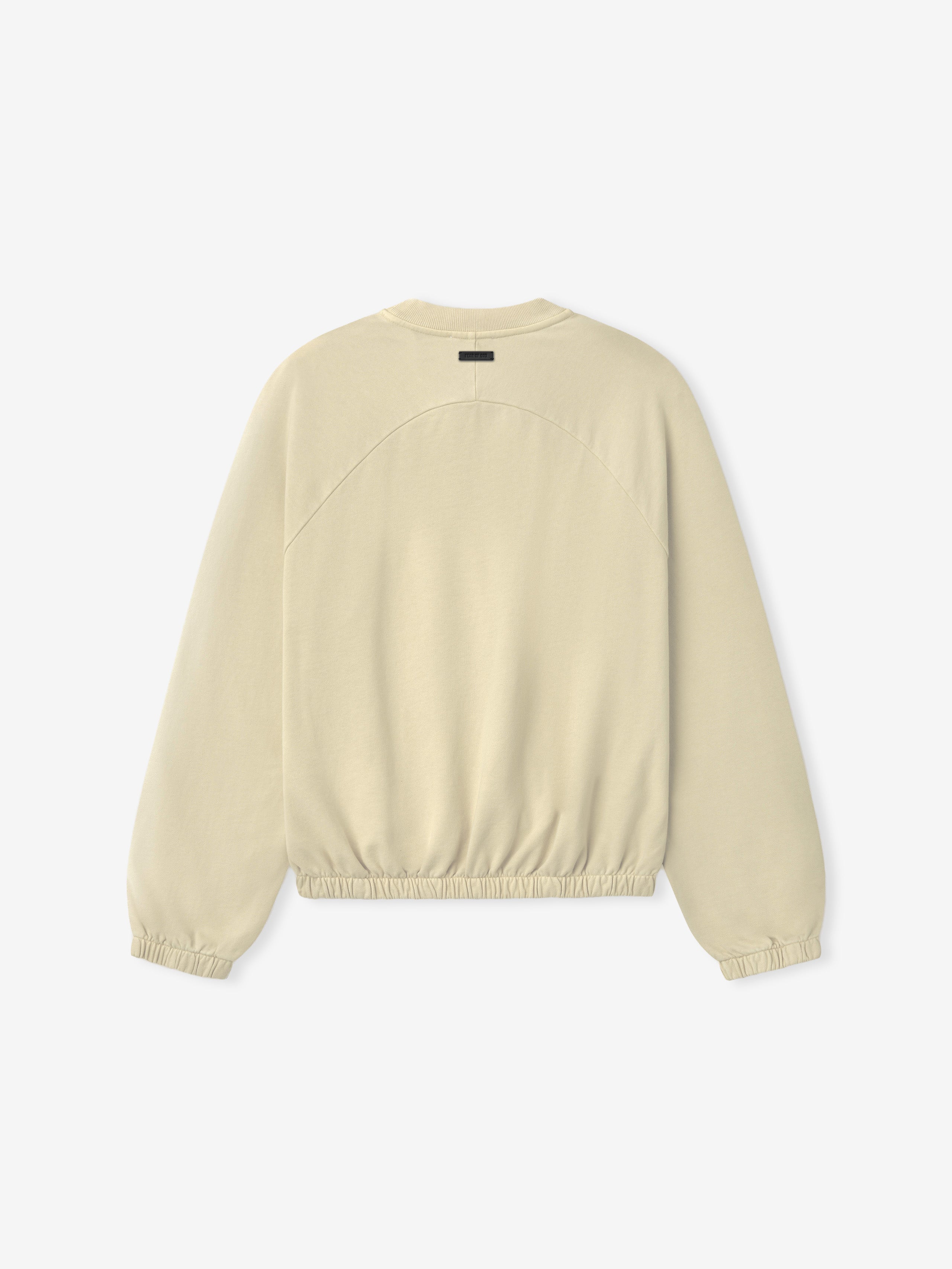 Back view of a dirty ivory long-sleeve crewneck sweatshirt with elasticated cuffs and gathered hem on plain background