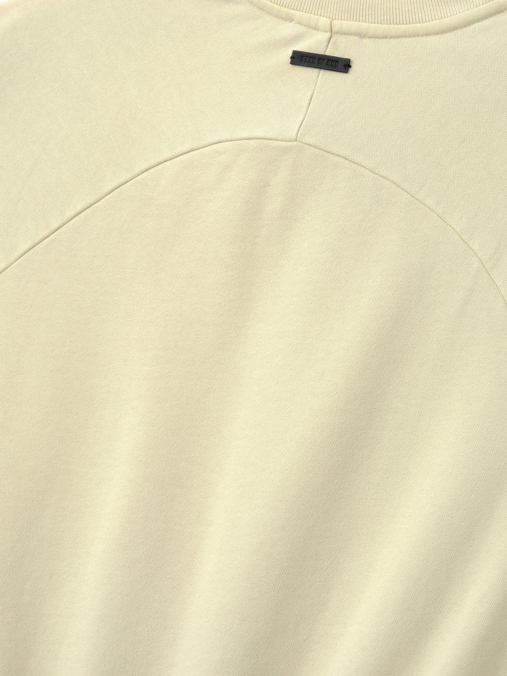 Close-up of a white garment with a brand label on a white background