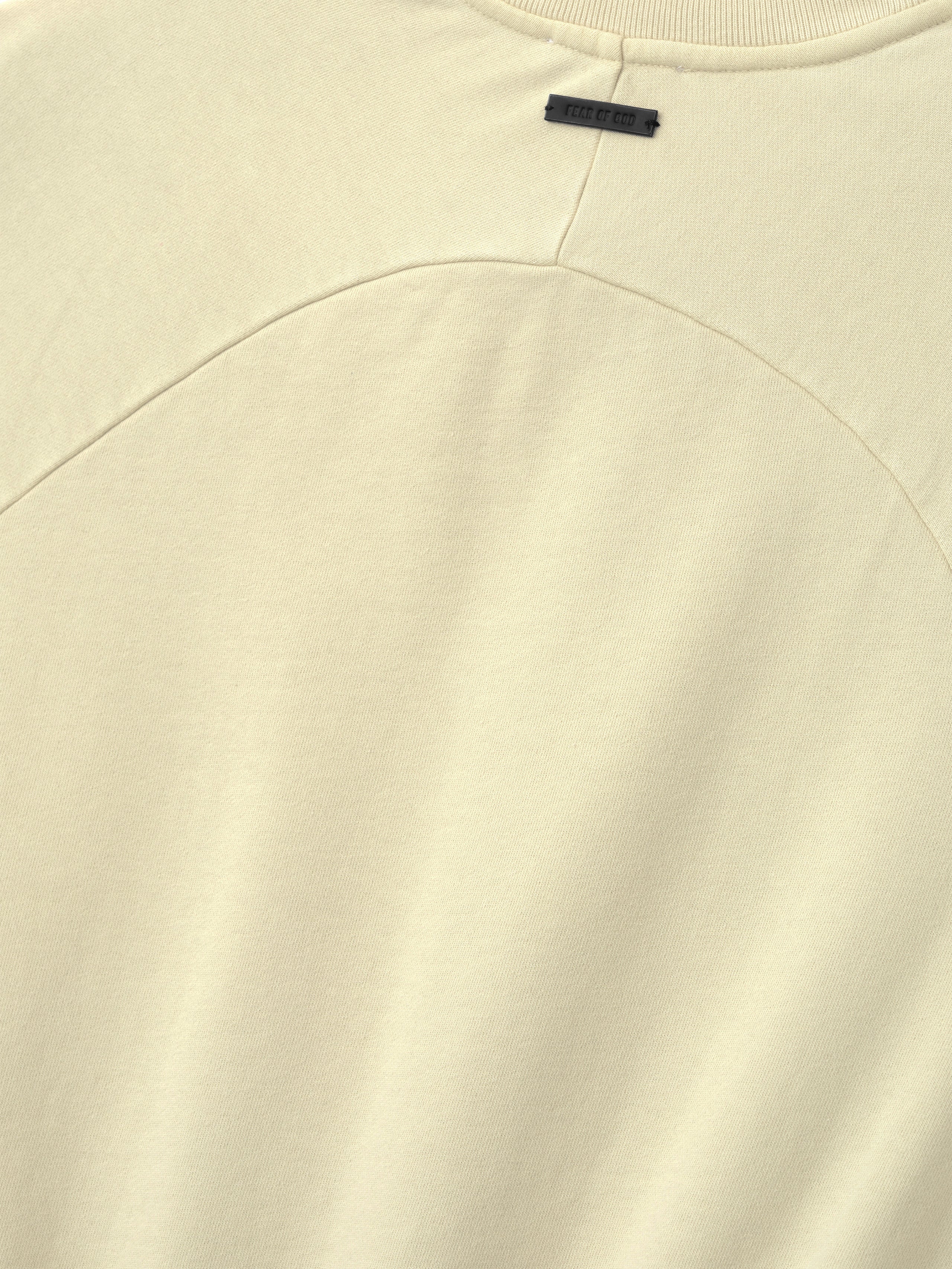 Close-up of a white garment with a brand label on a white background