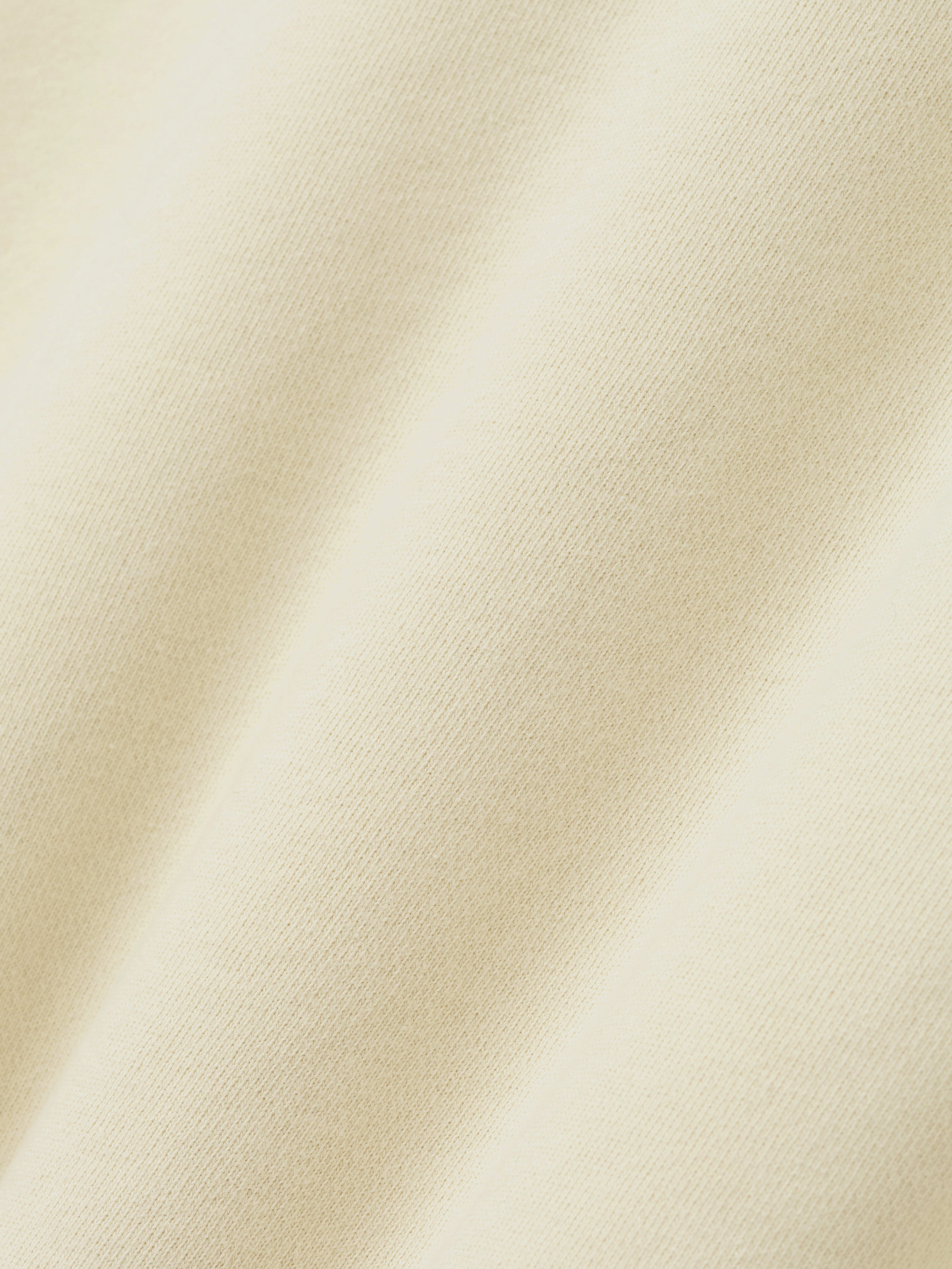 Close-up of a textured beige fabric surface