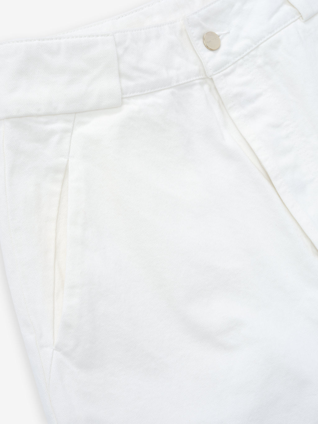 close-up of white cotton broken twill womens utility pant with side seam pocket and metal snap button closure