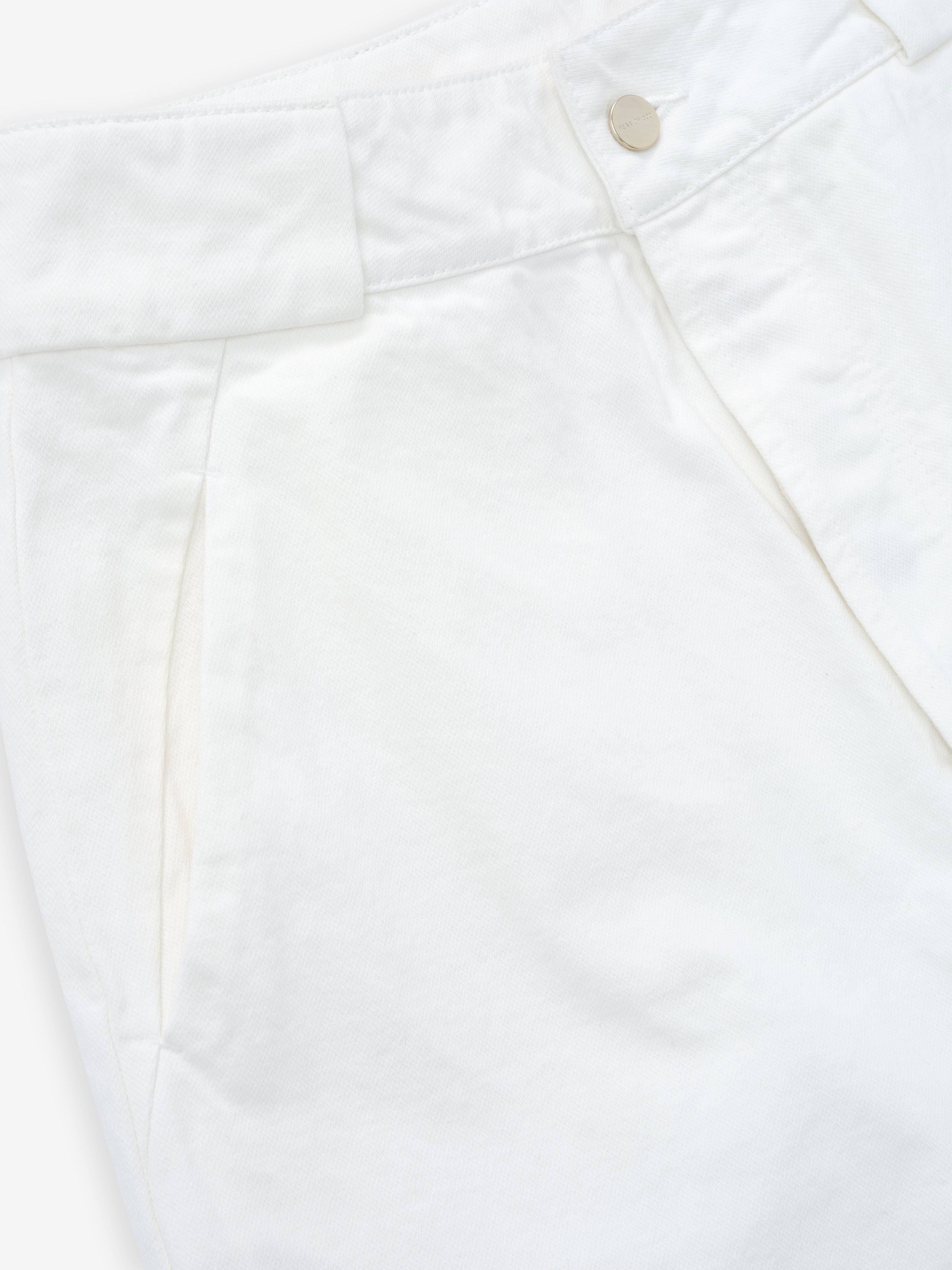 close-up of white cotton broken twill womens utility pant with side seam pocket and metal snap button closure
