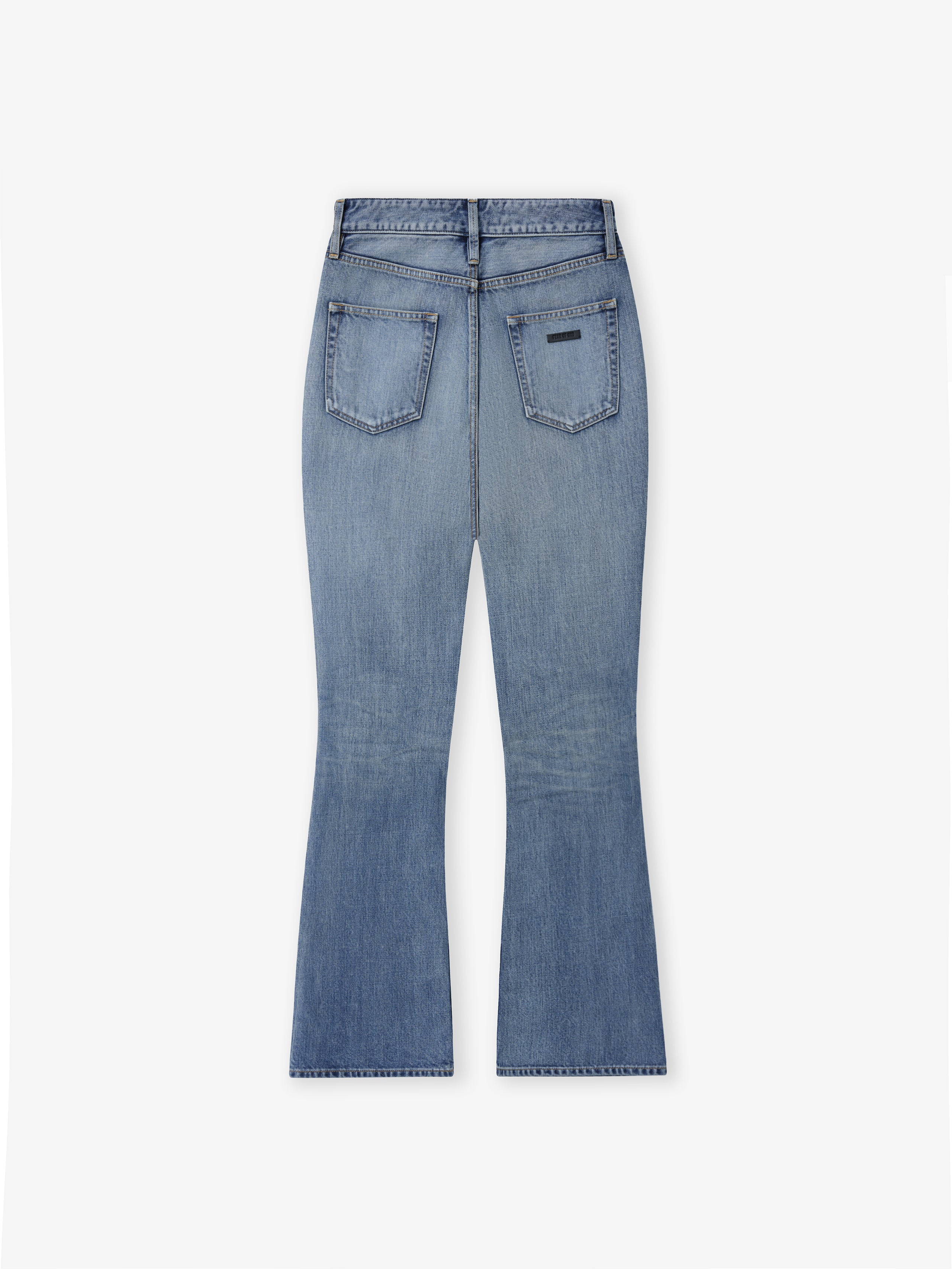 back view of classic blue indigo 100% cotton denim jeans with relaxed fit flared legs and rear patch pockets