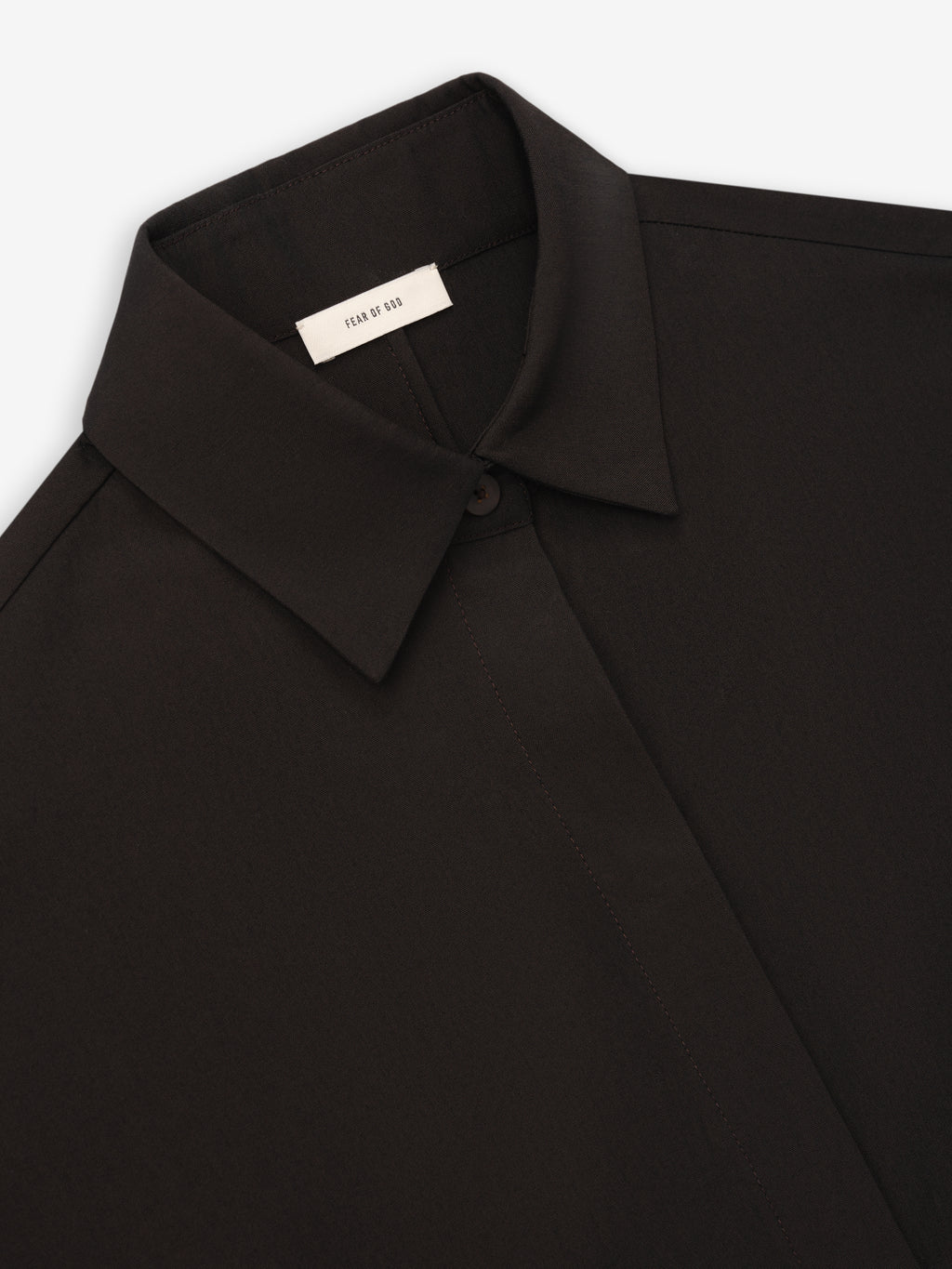 Close-up of black collared shirt with concealed button placket and smooth fabric texture on a white background