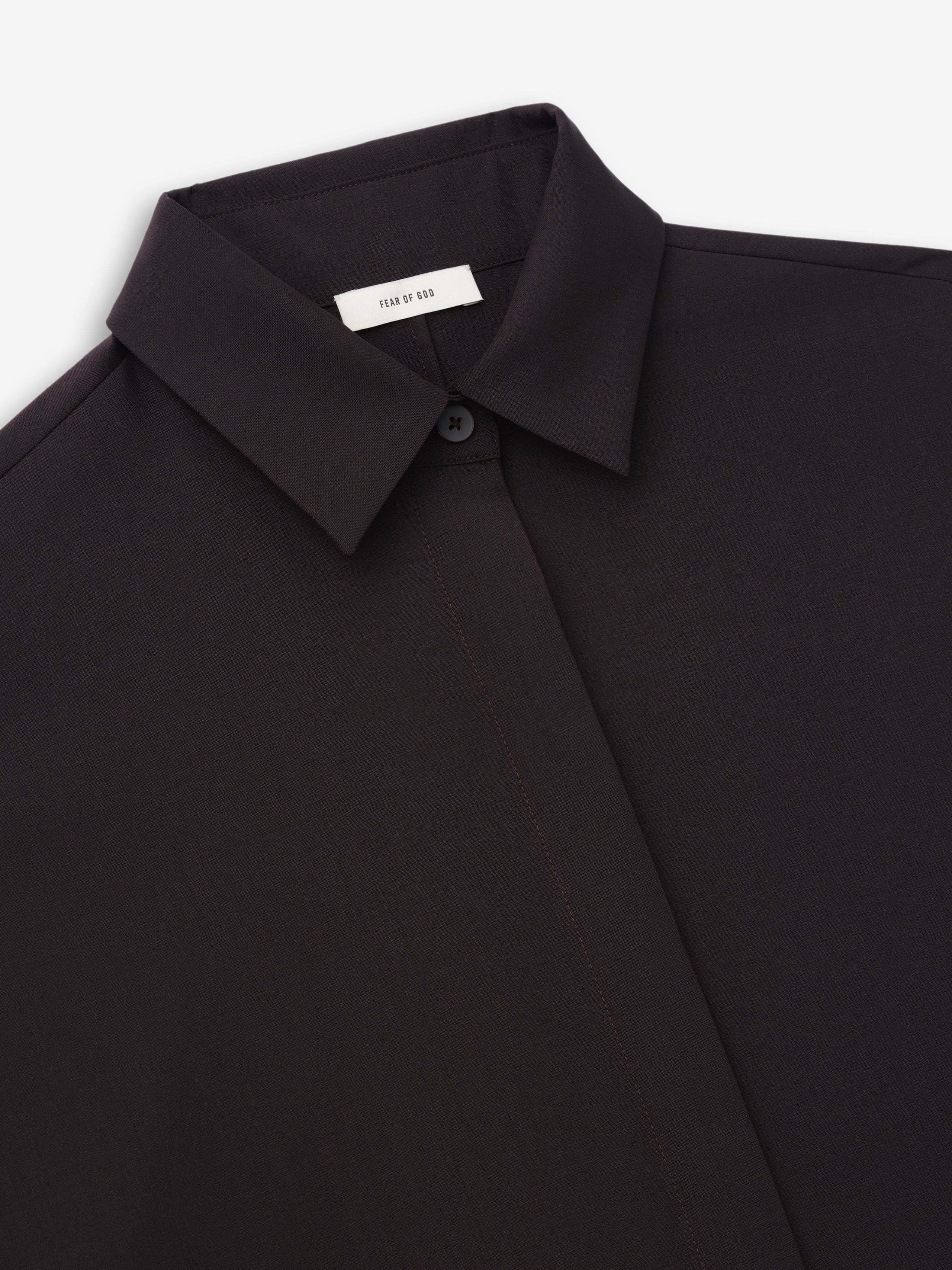 close-up of black women's relaxed fit shirt in superfine wool canvas with hidden button placket and classic collar