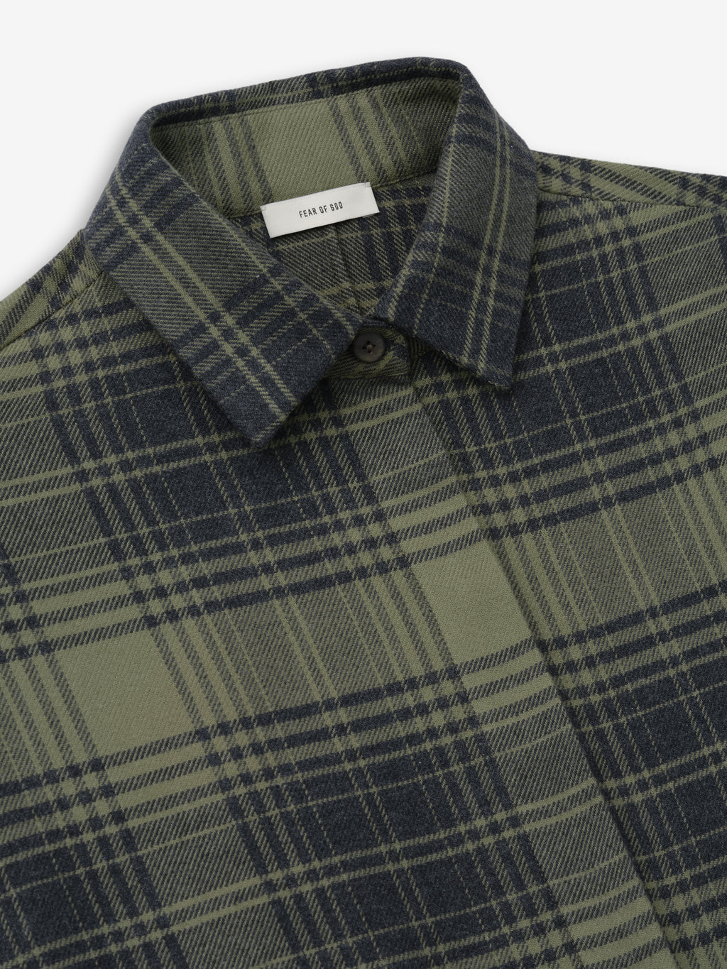 close-up of green and black plaid cotton flannel relaxed fit women's shirt with classic collar and hidden button placket