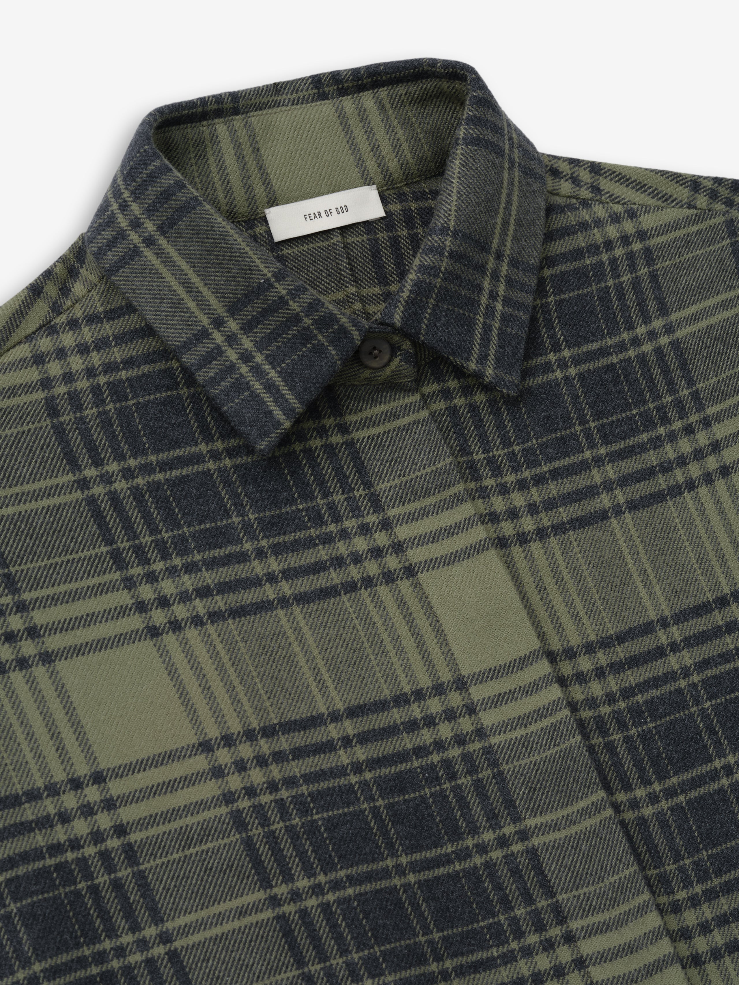 close-up of green and black plaid cotton flannel relaxed fit women's shirt with classic collar and hidden button placket