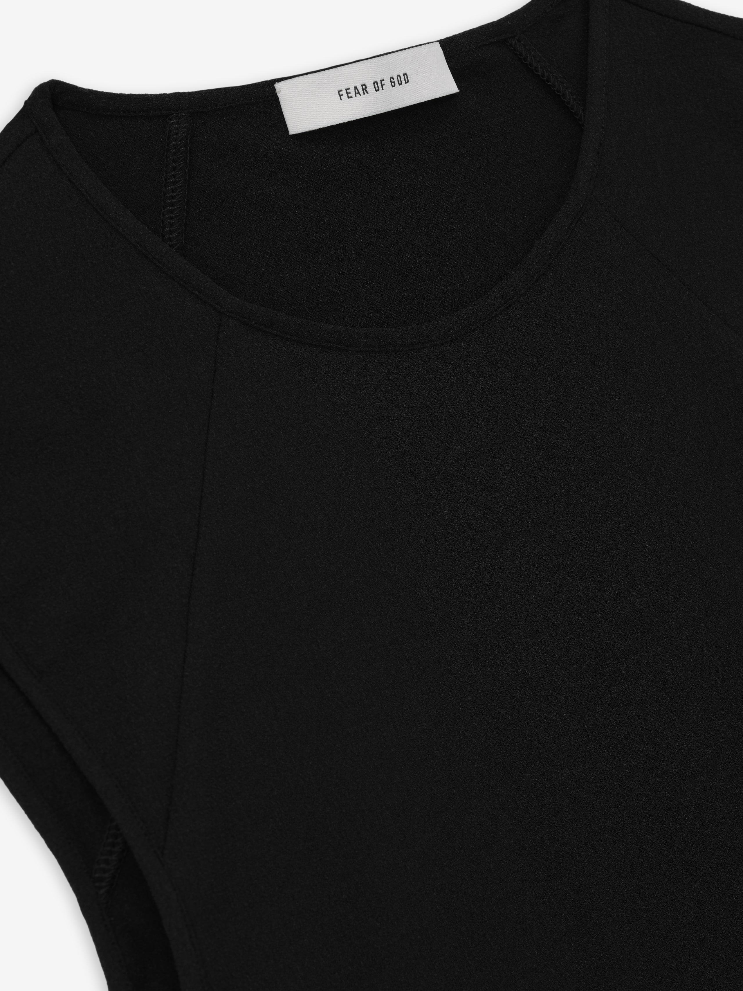 close-up of black sleeveless tank top with raglan seams and fine tubular neckline in slightly sheer silk elastane fabric