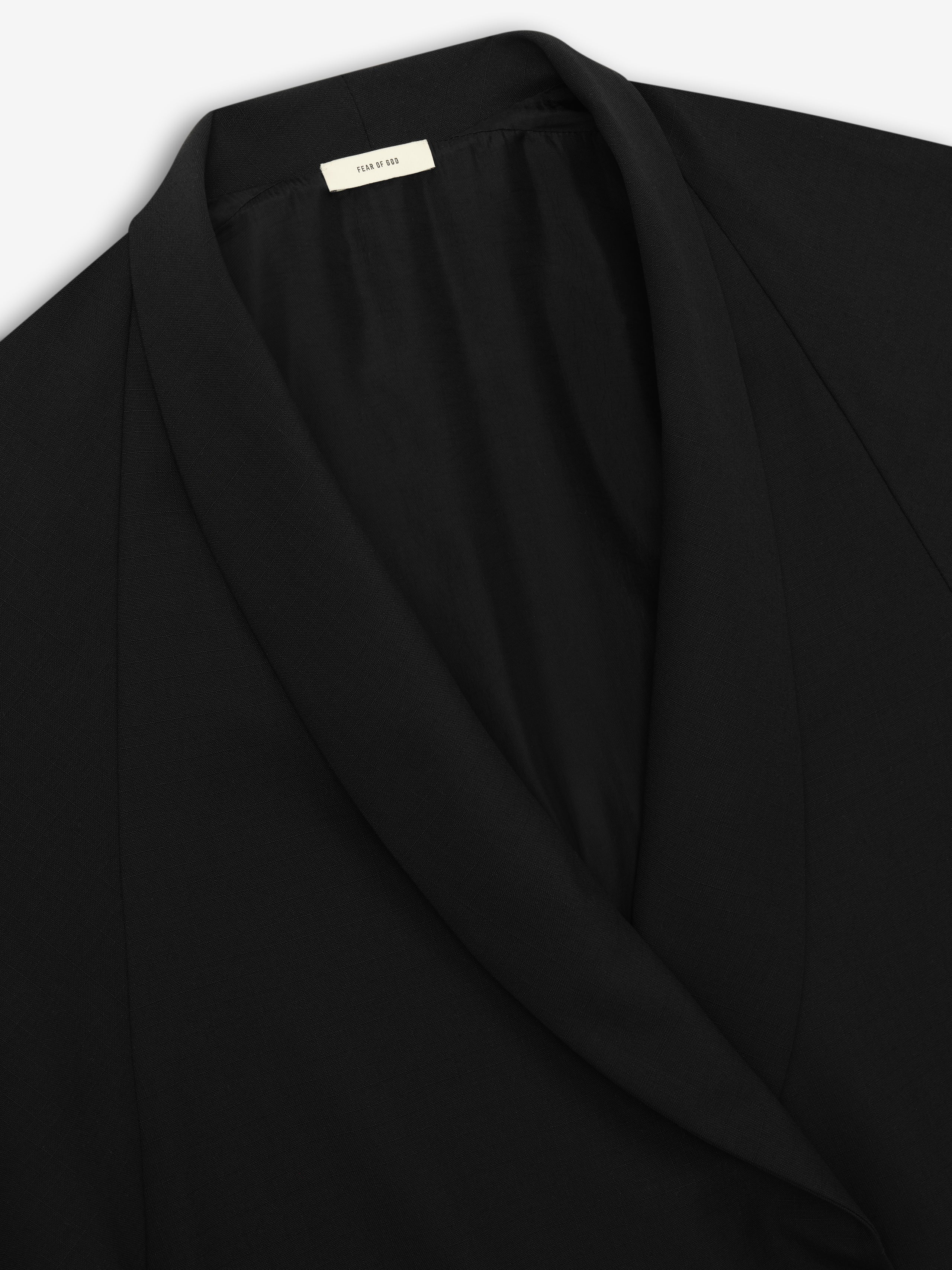 close-up of black shawl collar on lightweight tailored wool ripstop jacket with smooth sculpted drape